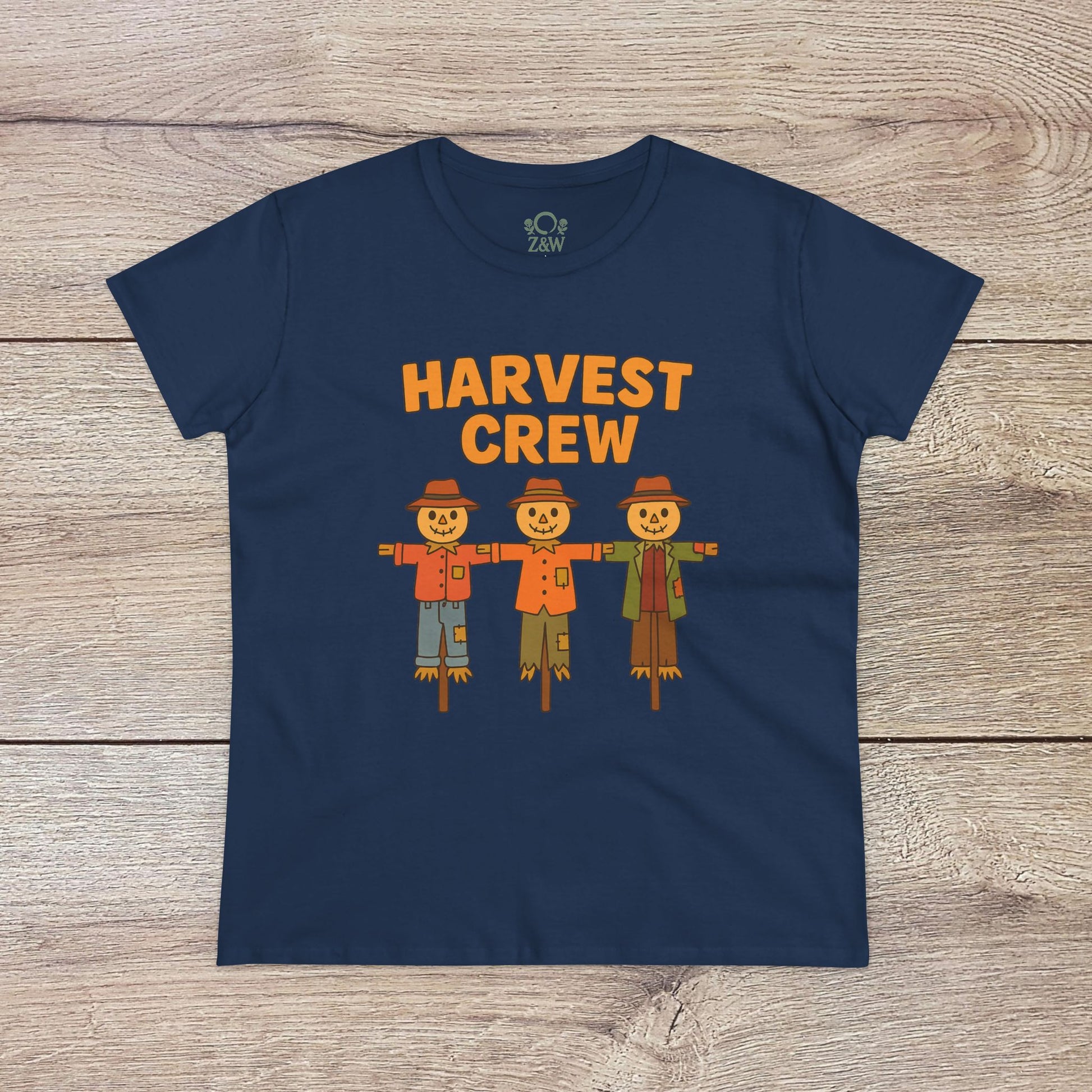 Harvest Crew Halloween T-Shirt in navy blue featuring cheerful scarecrow characters with the text 'Harvest Crew'. Made from soft 100% ring-spun cotton, it offers a classic fit and eco-friendly style.