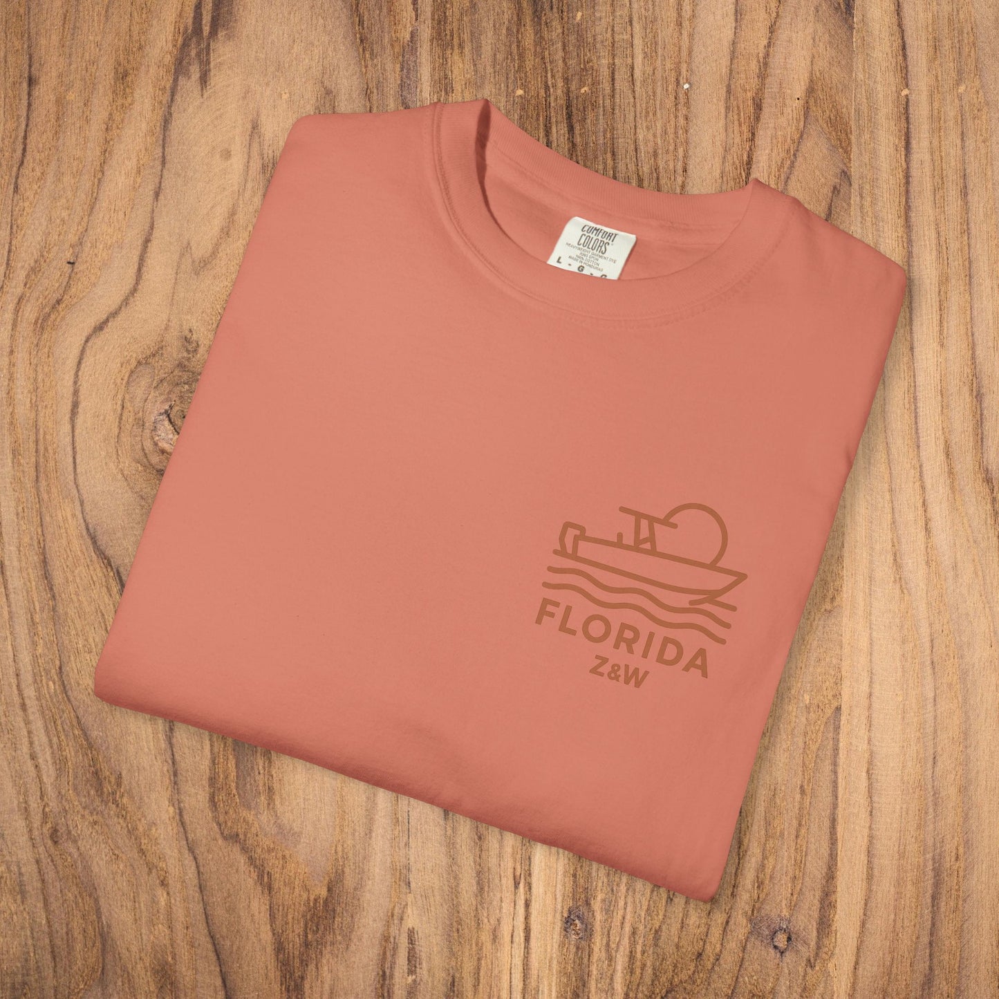 Unisex Florida Graphic Tee, garment-dyed in soft coral, showcased in a flat lay to display its stylish design.