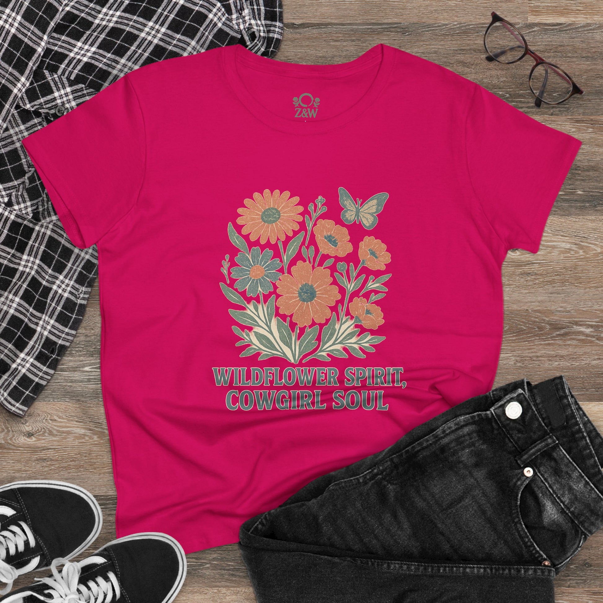 Wildflower Spirit Cotton Tee in bright pink, adorned with colorful floral artwork and the phrase 'Wildflower Spirit, Cowgirl Soul', combining comfort with style.