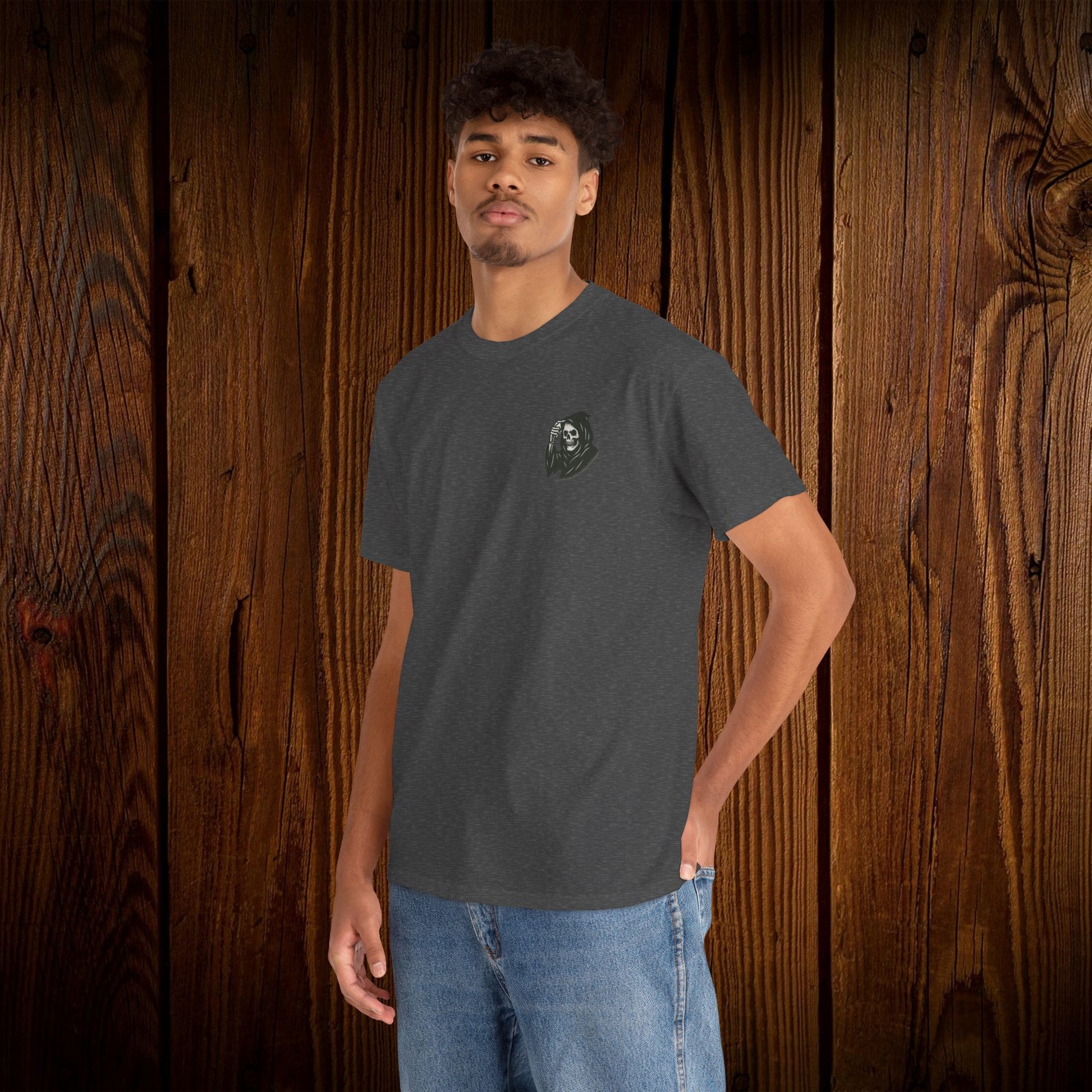Spooky Halloween Graphic Tee featuring a unique ghosts print on a unisex cotton shirt, modeled by a young man against a rustic wooden background.