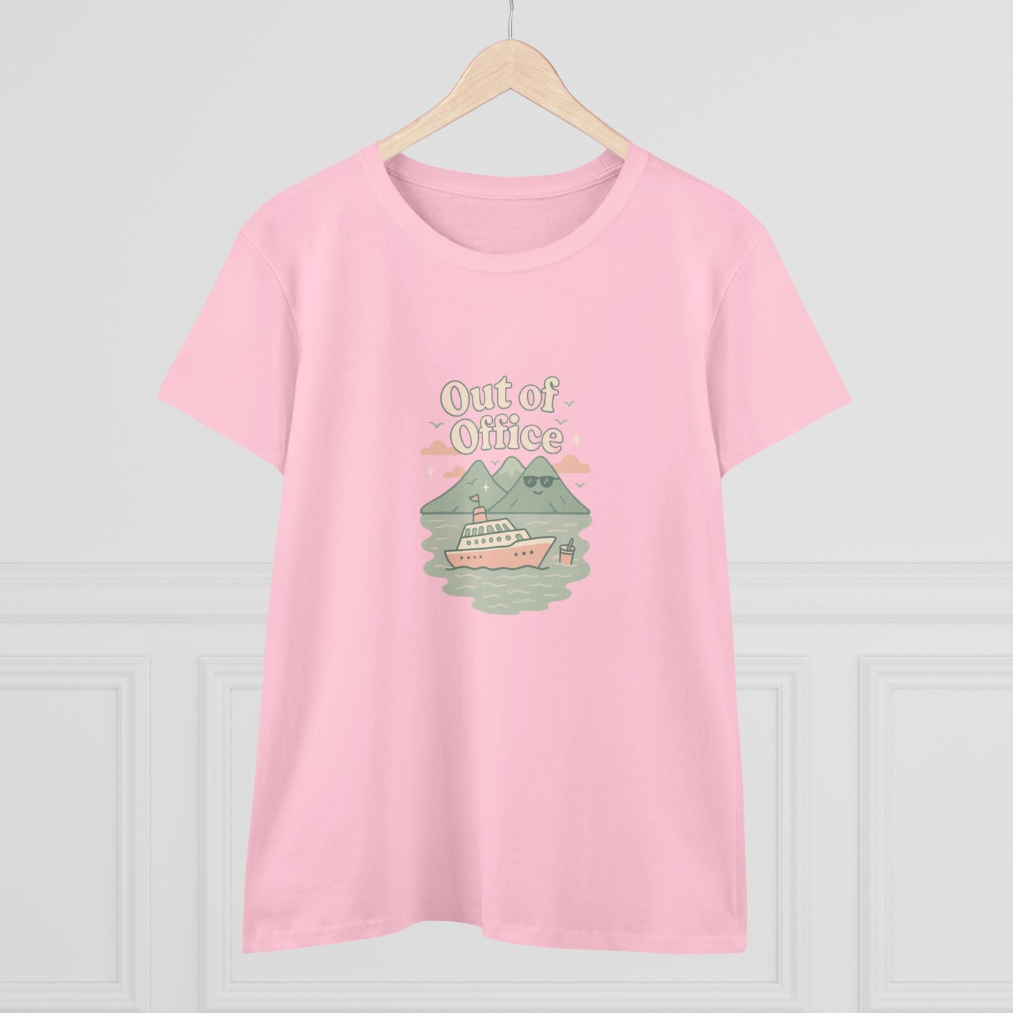 Out Of Office Cruise Tee in pink, elegantly displayed on a hanger. Features a charming boat and mountain illustration, great for casual summer attire.