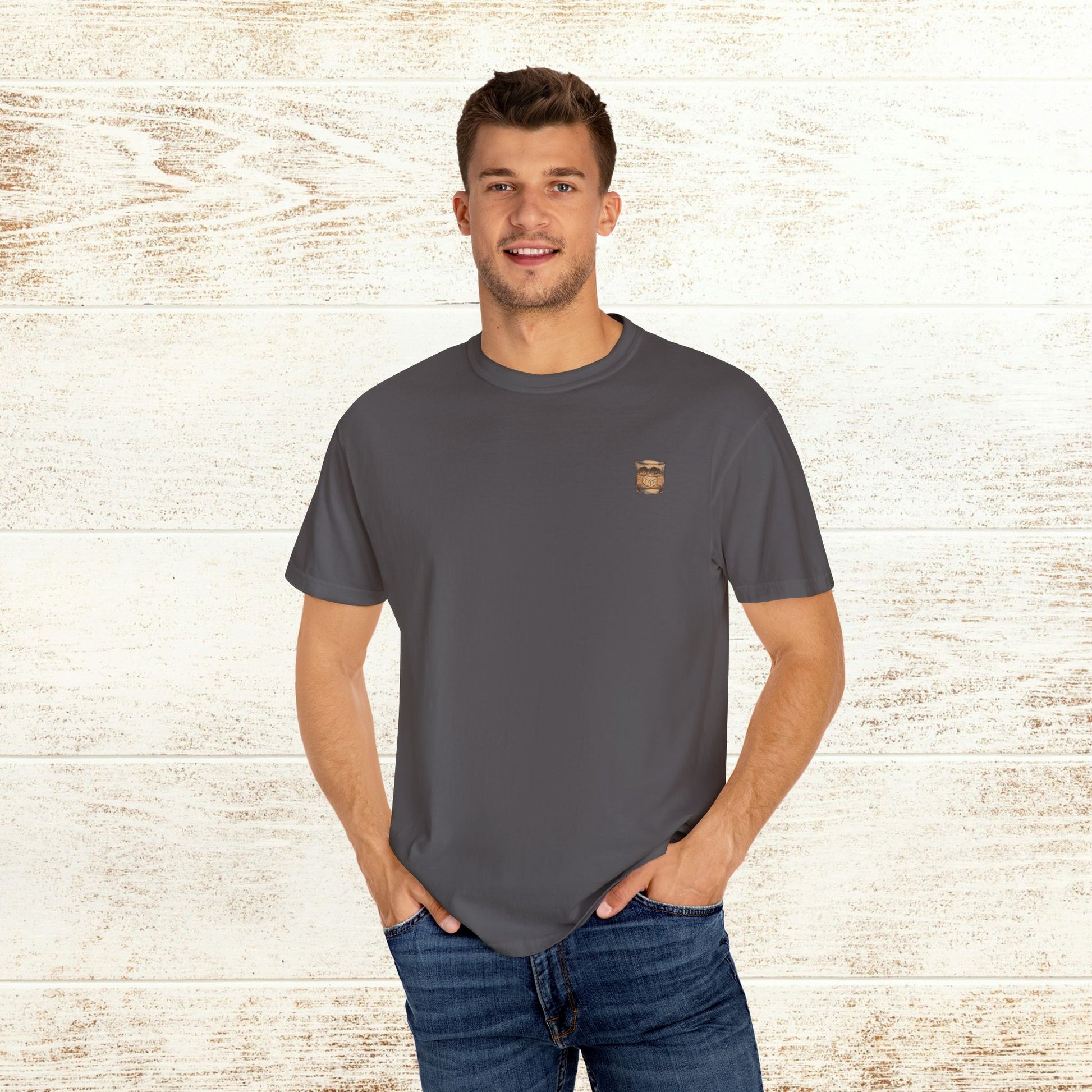 Men's Rodeo On The Rocks Tee in dark gray, model smiling while wearing a comfortable 100% US cotton shirt.