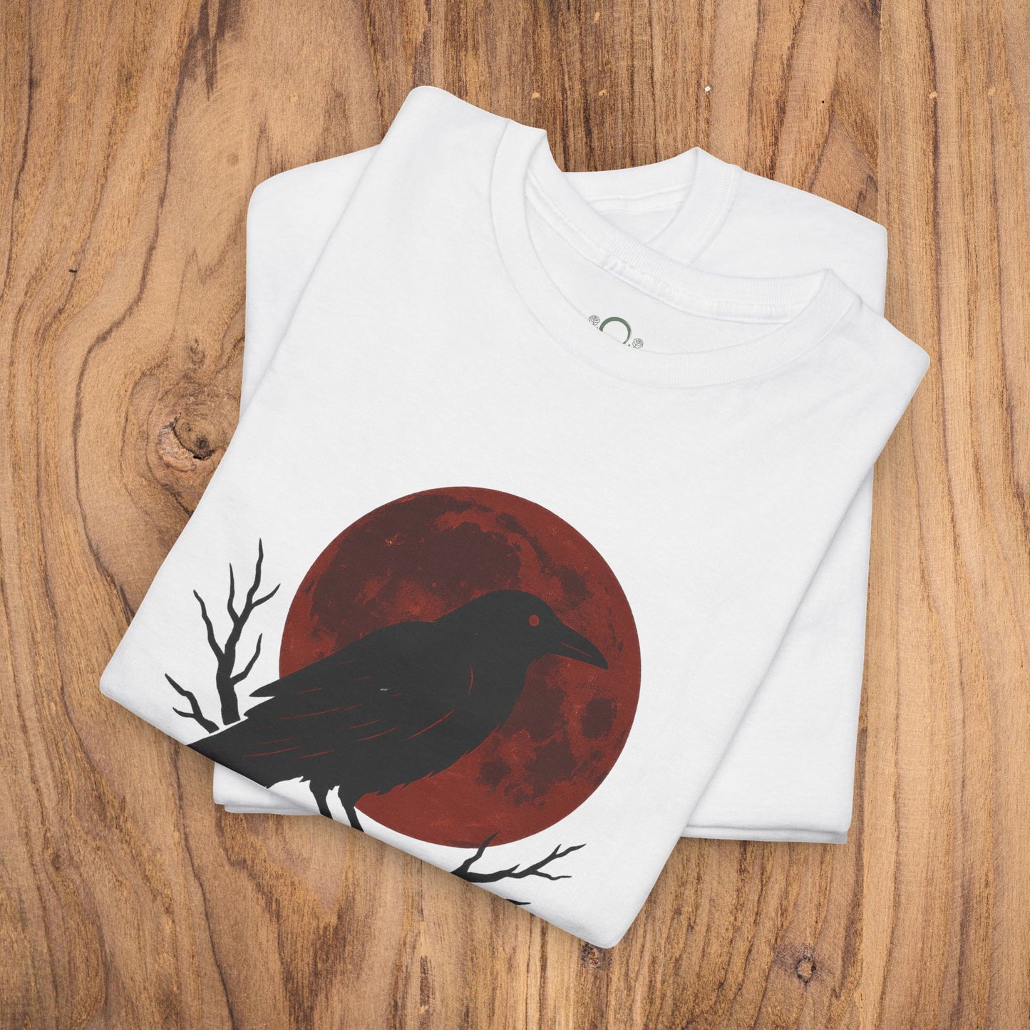 Gothic Raven T-Shirt featuring a raven and red moon design, perfect for Halloween festivities. This heavy cotton tee makes a unique spooky gift and is a stylish addition to casual fall fashion.