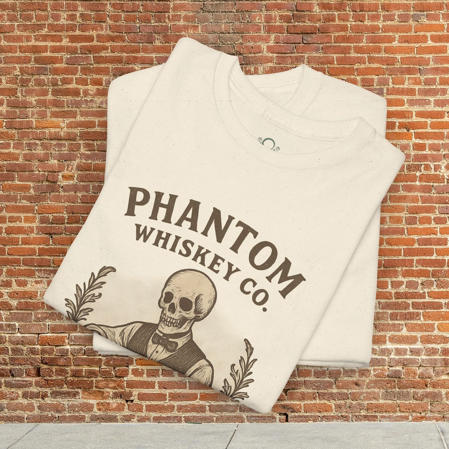 Stack of Vintage Skull Whiskey Lover Unisex Tees displayed against a brick background, highlighting the unique skeleton design. Ideal for Halloween gifting.