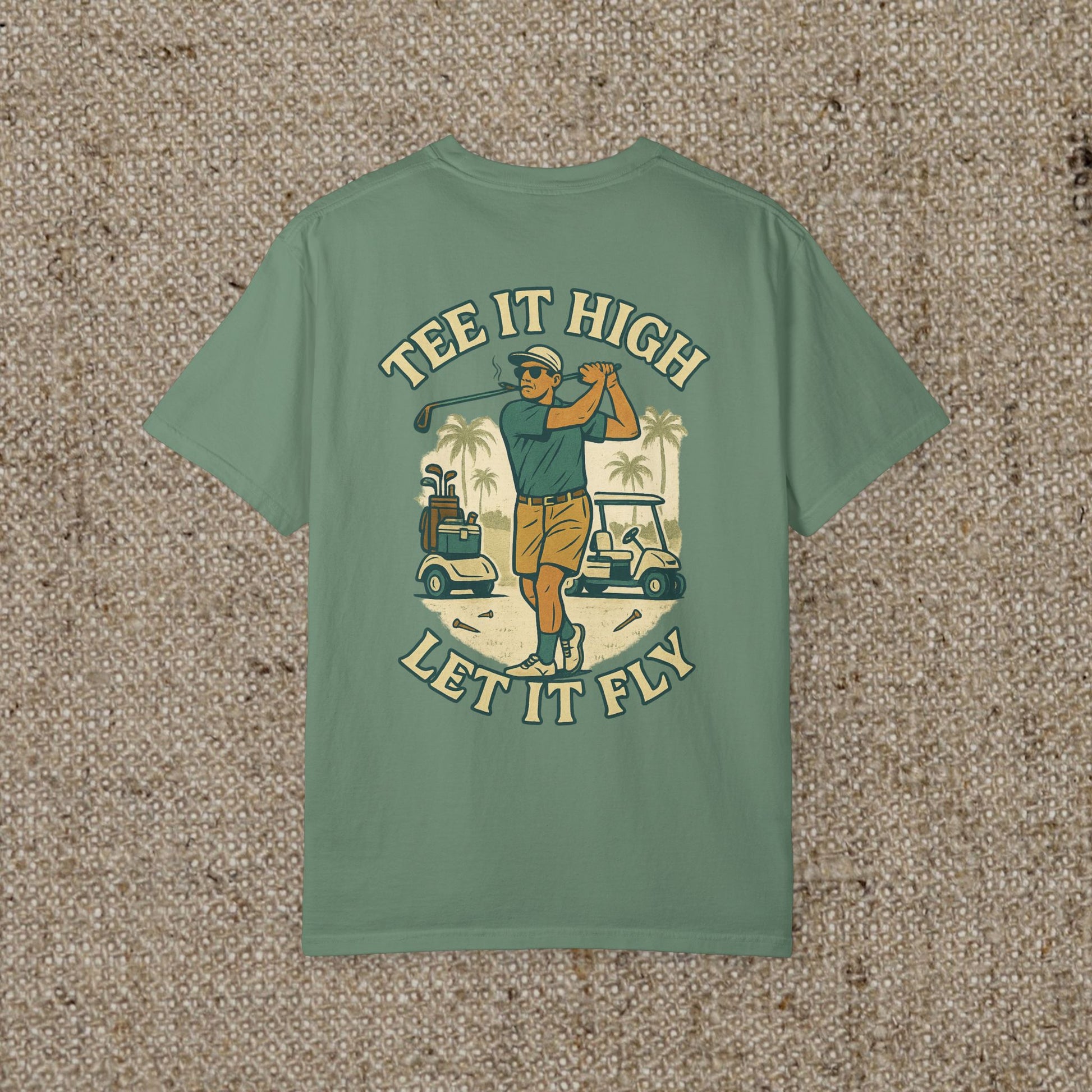 Back view of the 'Tee It High Let It Fly Graphic Tee', featuring a golfer in action against a golf course background, designed for style and comfort.