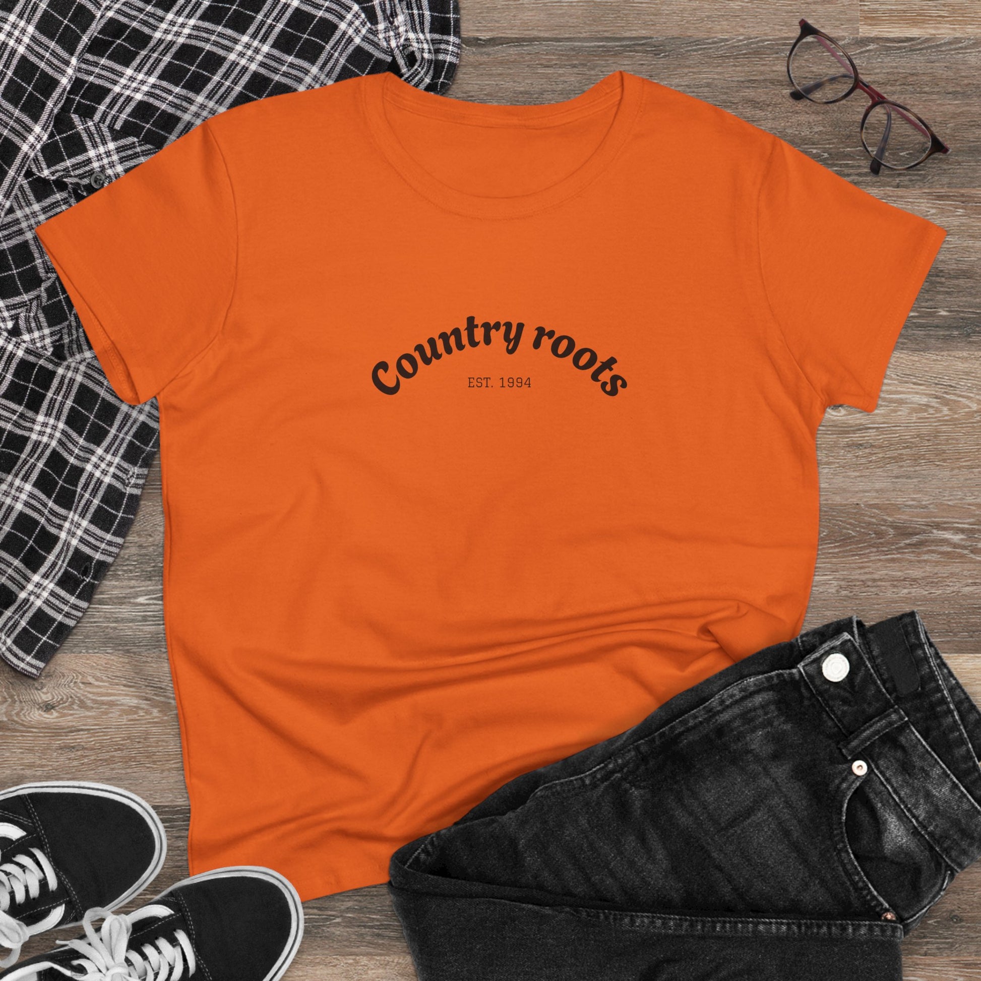 Stylish Country Roots Cowgirl Tee in orange, paired with casual accessories, ideal for a laid-back look.