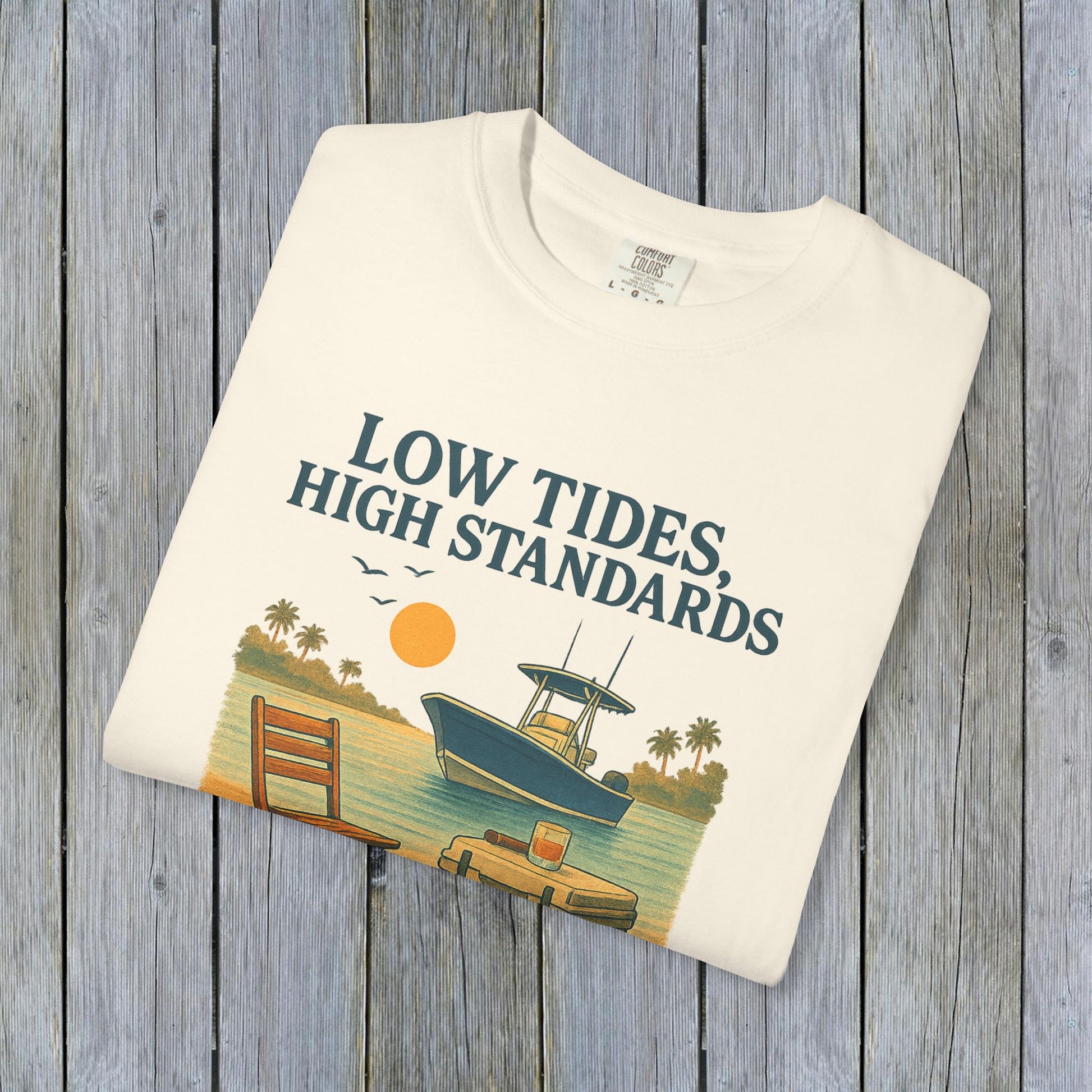 Garment-Dyed Low Tides High Standards T-Shirt in cream displaying a scenic boat and sunset illustration, perfectly blending comfort with a stylish look.