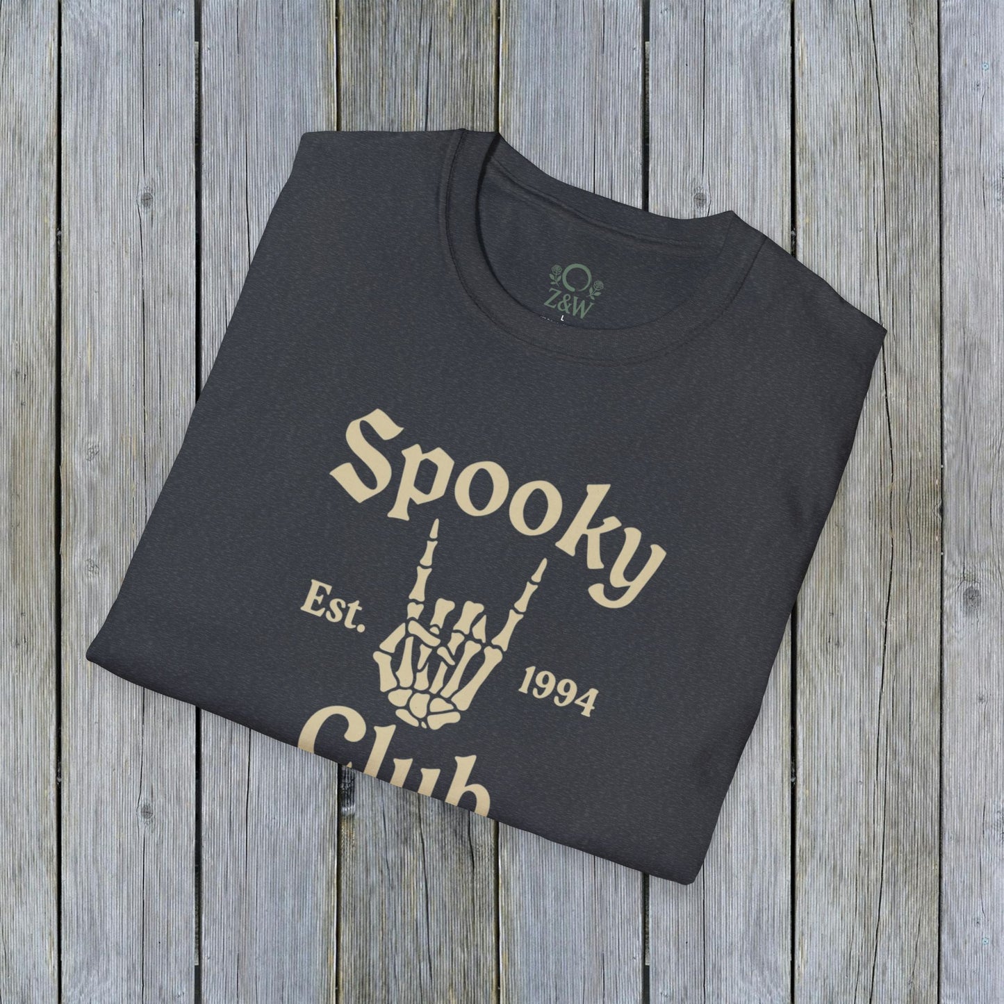 Unisex Spooky Club Tee in dark gray, highlighting an eye-catching skeleton hand illustration with 'Spooky Club Est. 1994' text, made from high-quality 100% cotton.