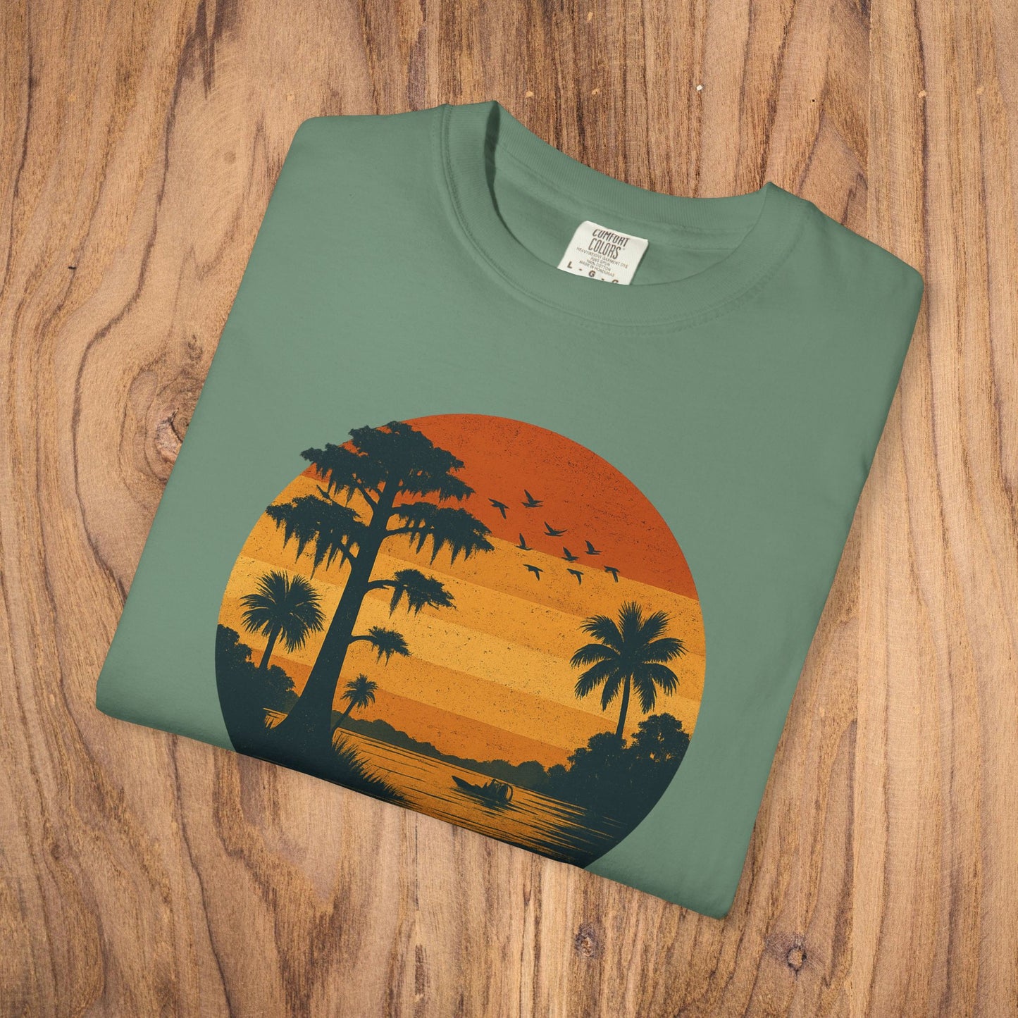 Unisex Garment-Dyed Sunset Tee showcasing a vibrant sunset design with palm trees, available in sizes S to 4XL, perfect for laid-back occasions.