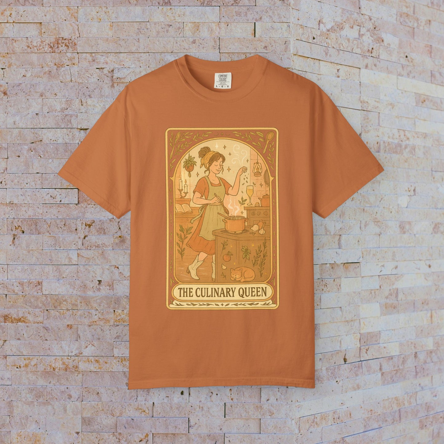 Culinary Queen Tarot Tee in burnt orange color, featuring a vintage-inspired design of a woman cooking with a whimsical background, available in sizes S to 4XL.
