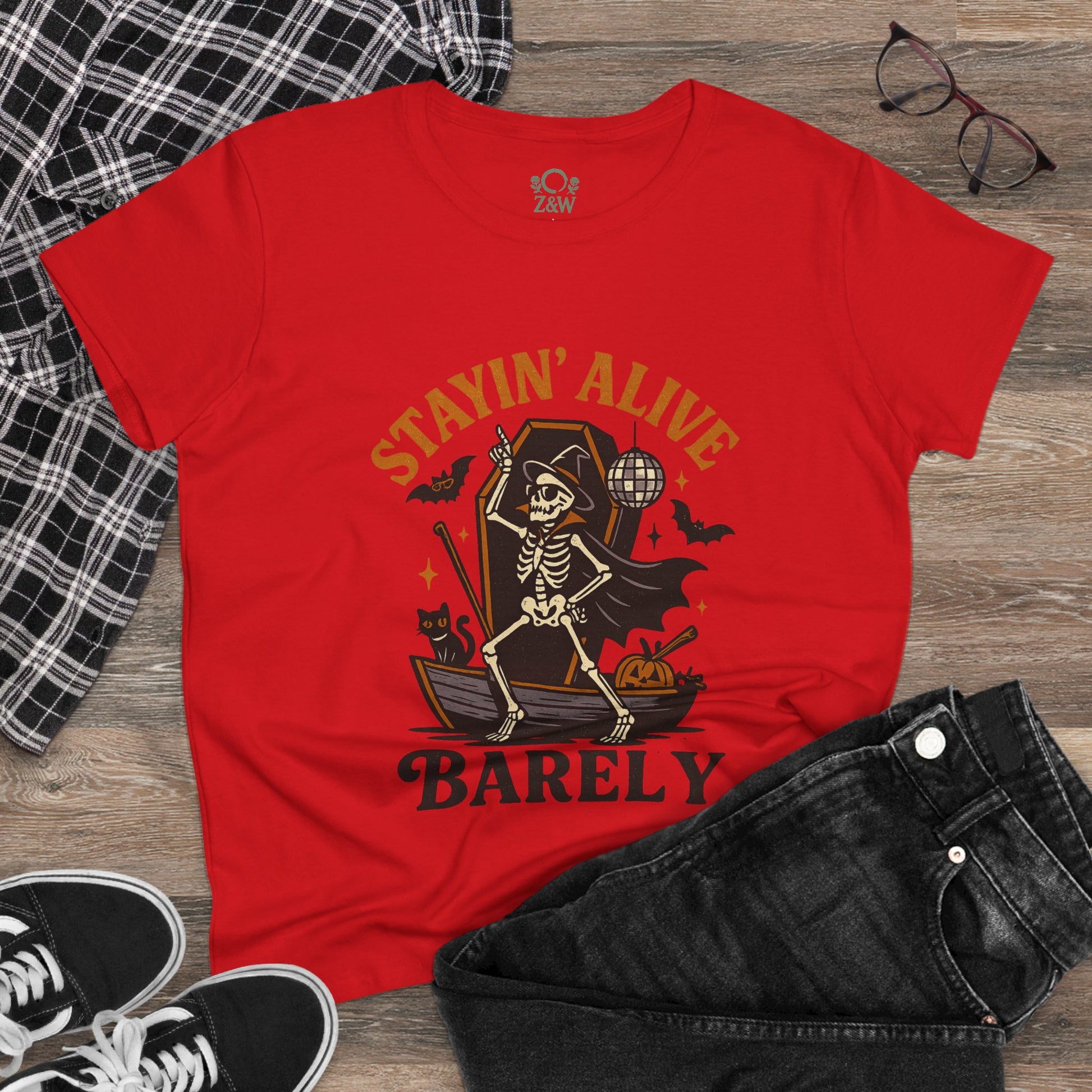 Casual red Stayin’ Alive T-Shirt paired with black jeans and sneakers, capturing a fun Halloween vibe.