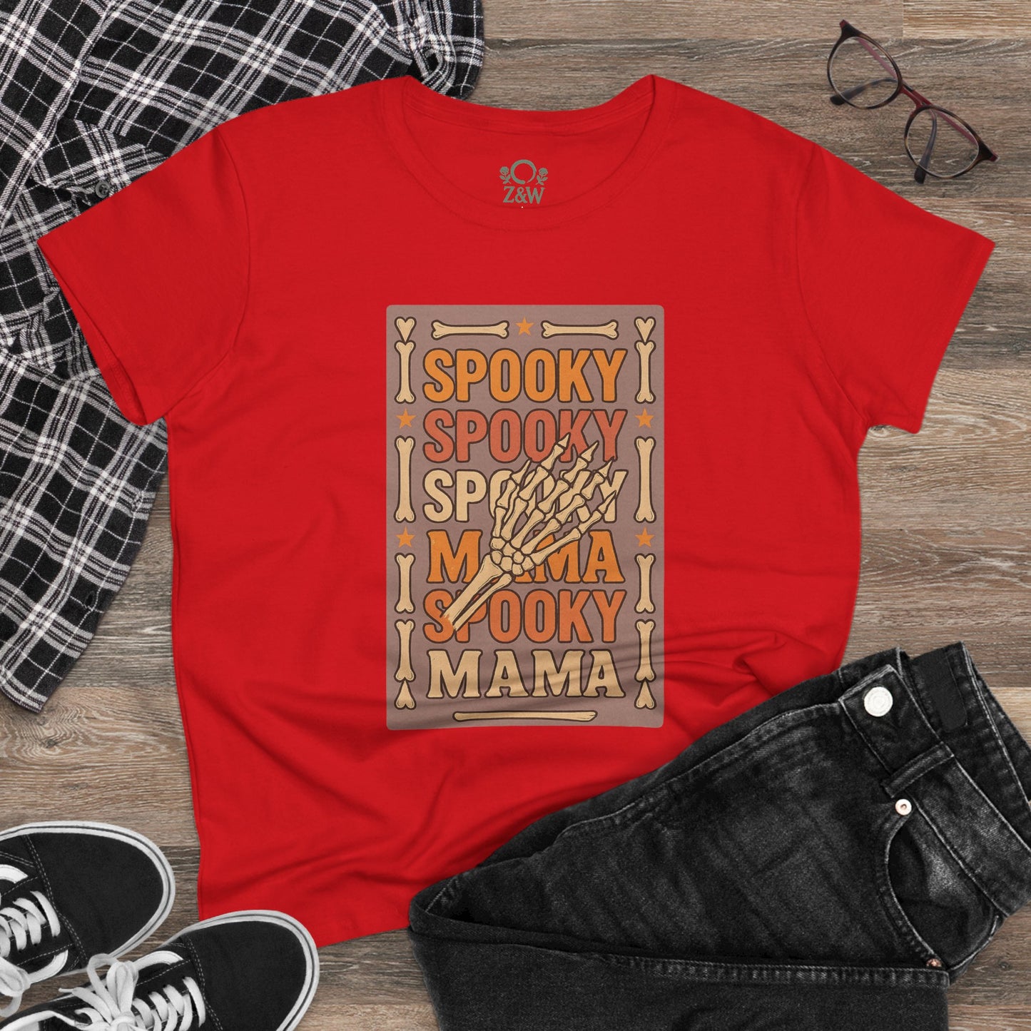 Spooky Mama Tee in dynamic red with a striking spooky graphic design, paired with stylish jeans, emphasizing its trendy look for various occasions.