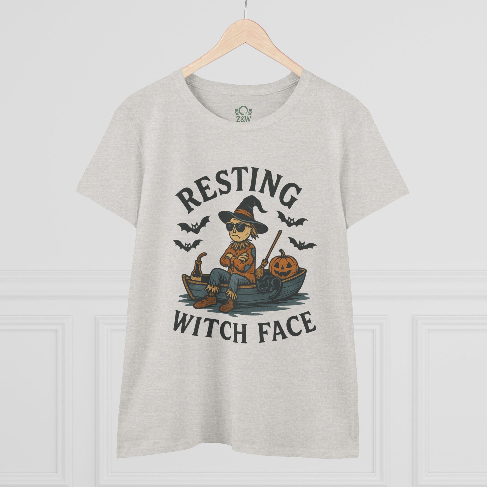 Front view of the light gray 'Resting Witch Face Halloween T-Shirt for Women, Unisex Funny Cotton Tee for Parties and Gifts' with a whimsical witch graphic, set against a stylish background.