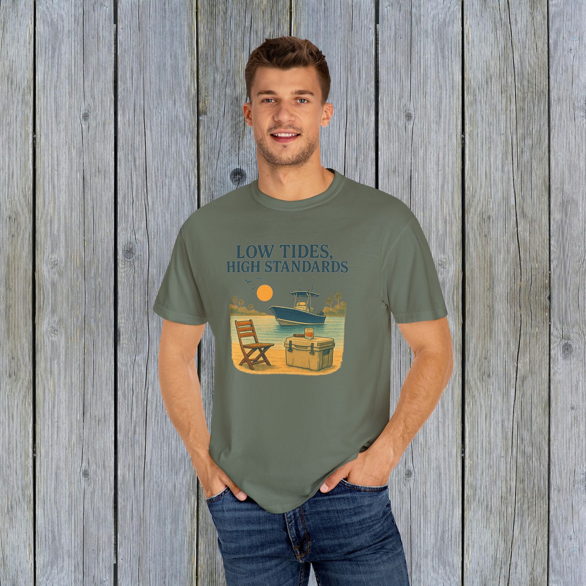 Model wearing the Garment-Dyed Low Tides High Standards T-Shirt in olive green, featuring a boat graphic and ideal for relaxed, stylish summer wear.