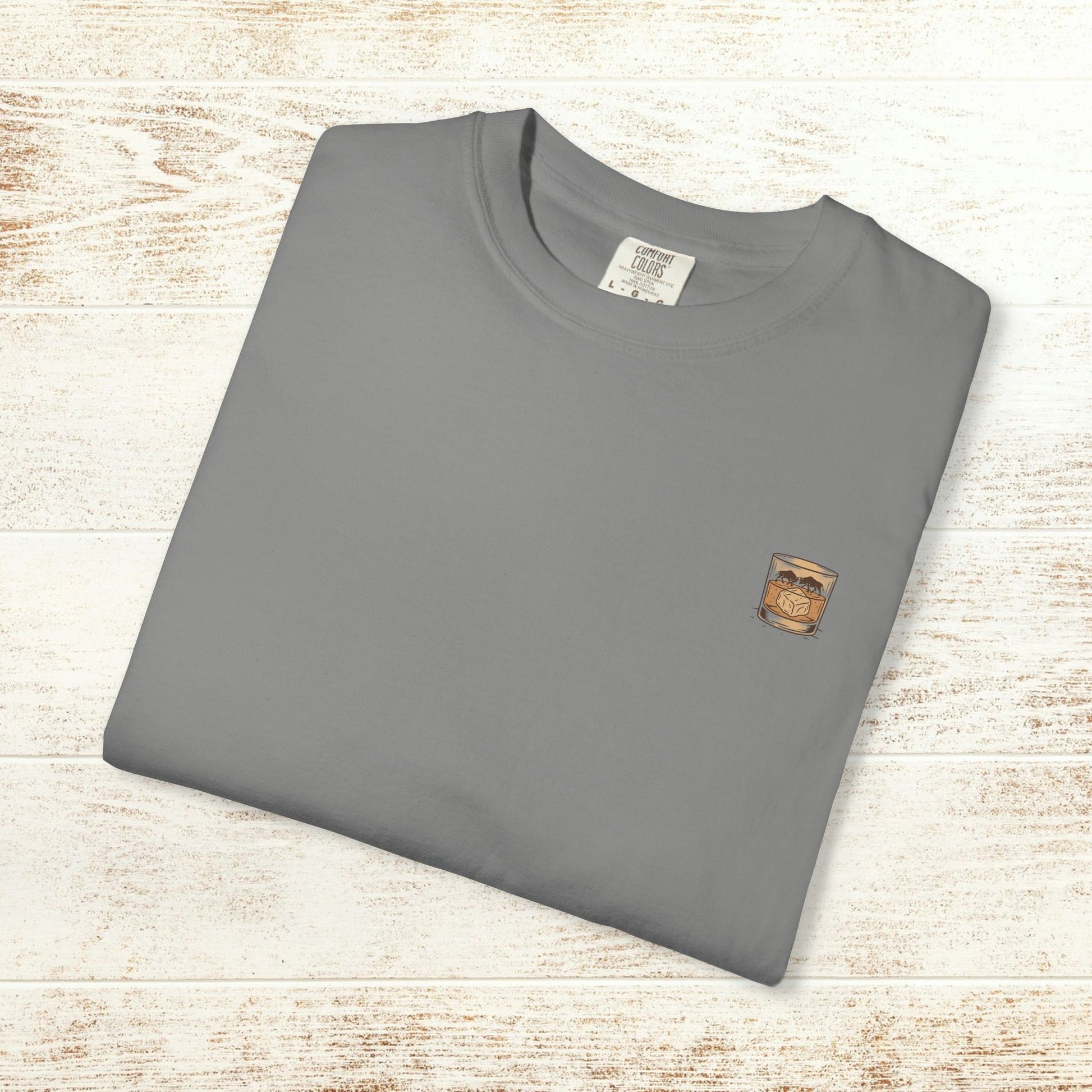 Folded gray Rodeo On The Rocks Tee displaying a unique drink illustration; ideal for casual wear, featuring a soft garment-dyed style.