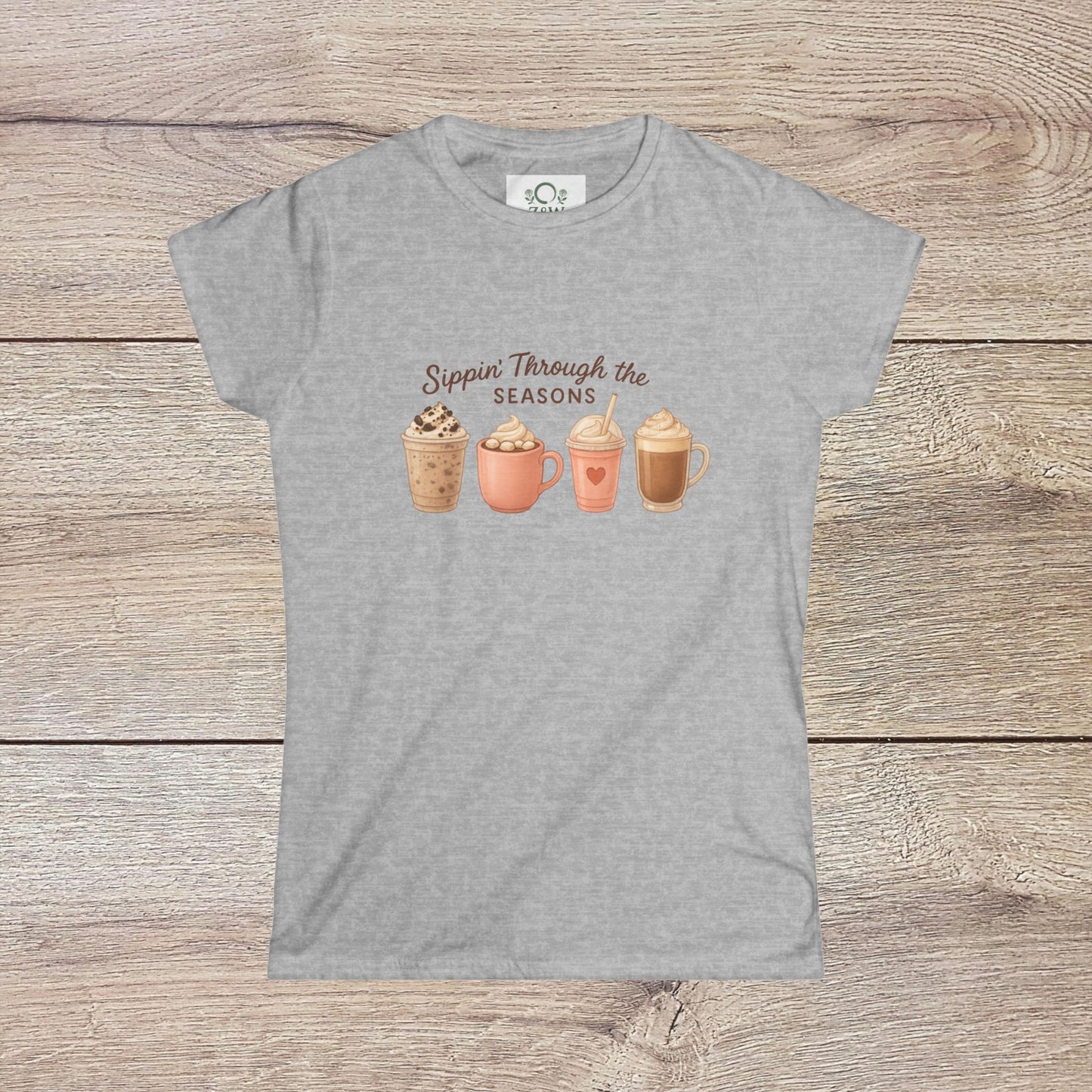 Sippin' Through The Seasons Slim Fit Tee in heather gray color featuring a playful design of seasonal beverage cups, made of 100% combed cotton with tear-away label.