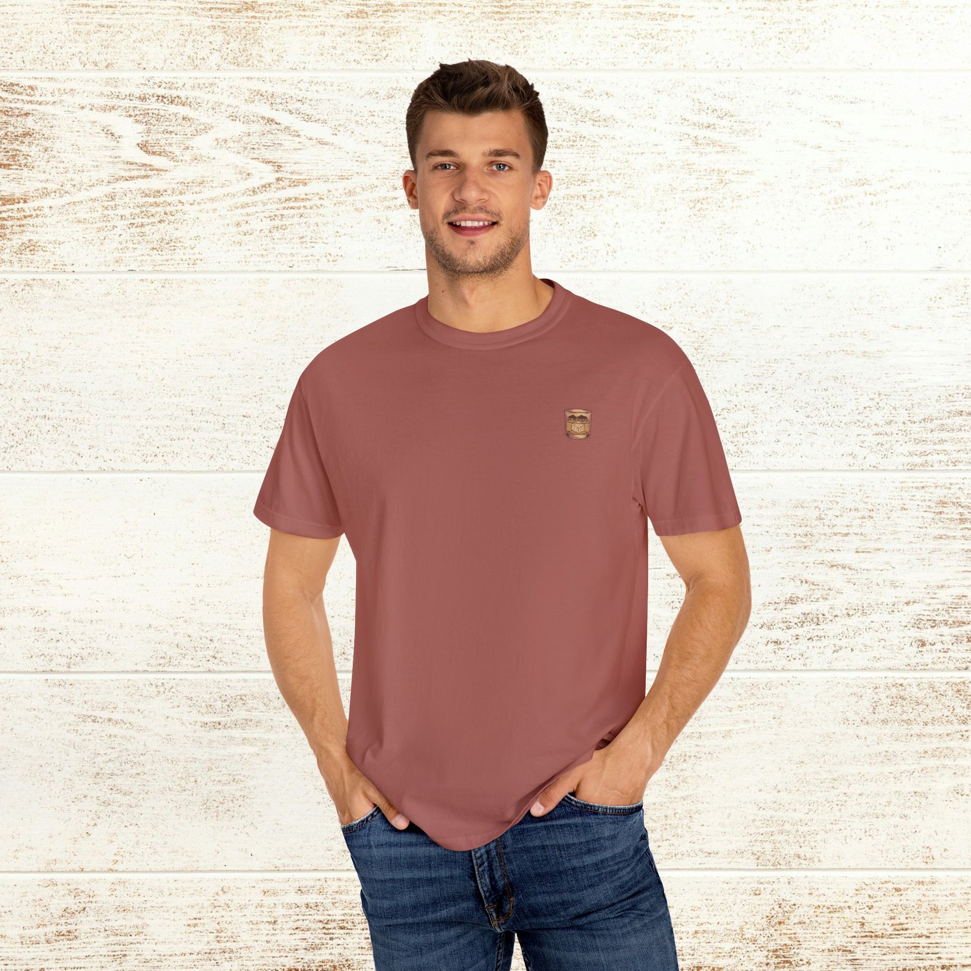 Model wearing the Rodeo On The Rocks Tee in a warm blush color, showcasing its soft 100% US cotton fabric, ideal for casual wear.
