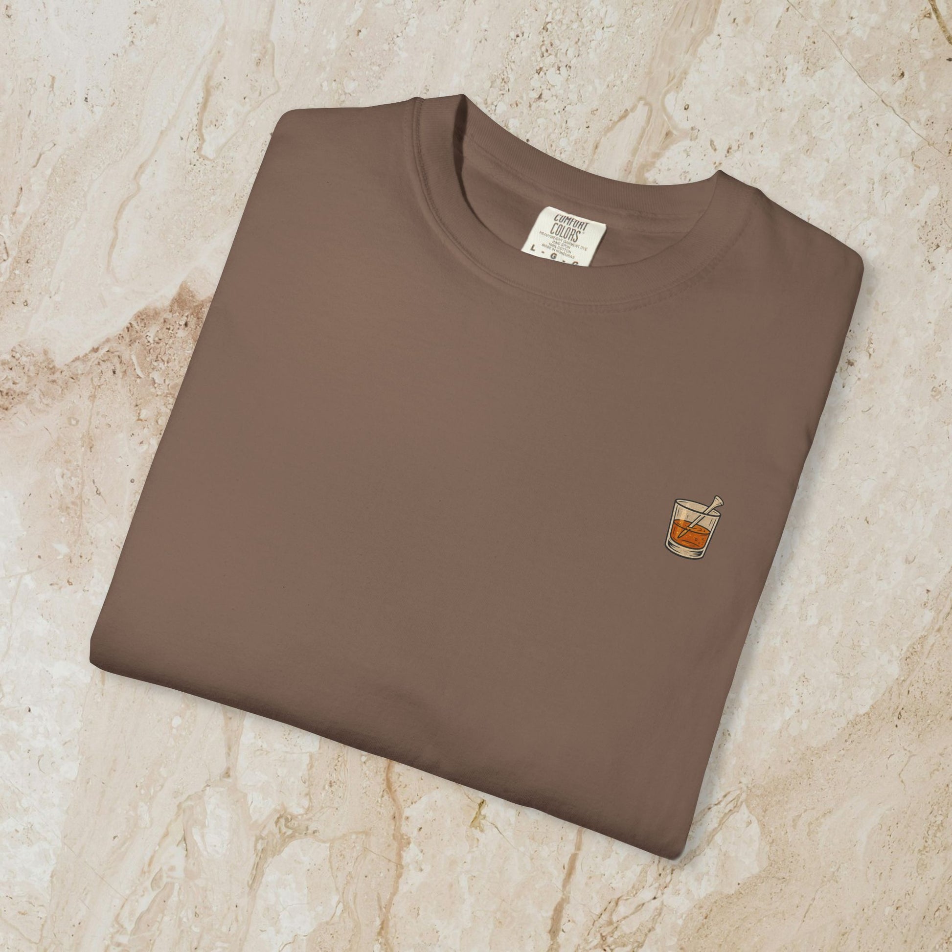 Golden Whiskey Dog Tee folded neatly, highlighting the unique left chest pocket with a whiskey glass design, crafted from soft ring-spun cotton.