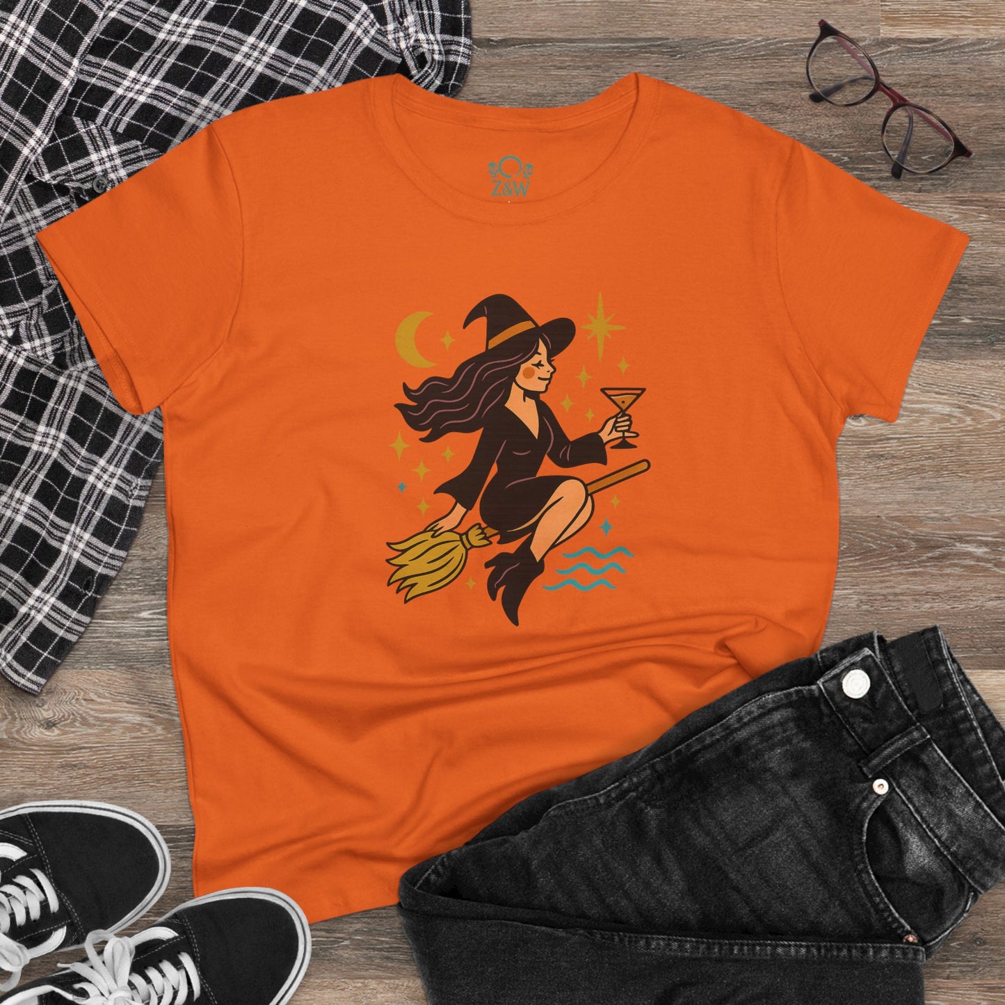 Casual setting of the Witchy Night Out Tee in orange, paired with denim and accessories, perfect for a trendy look.