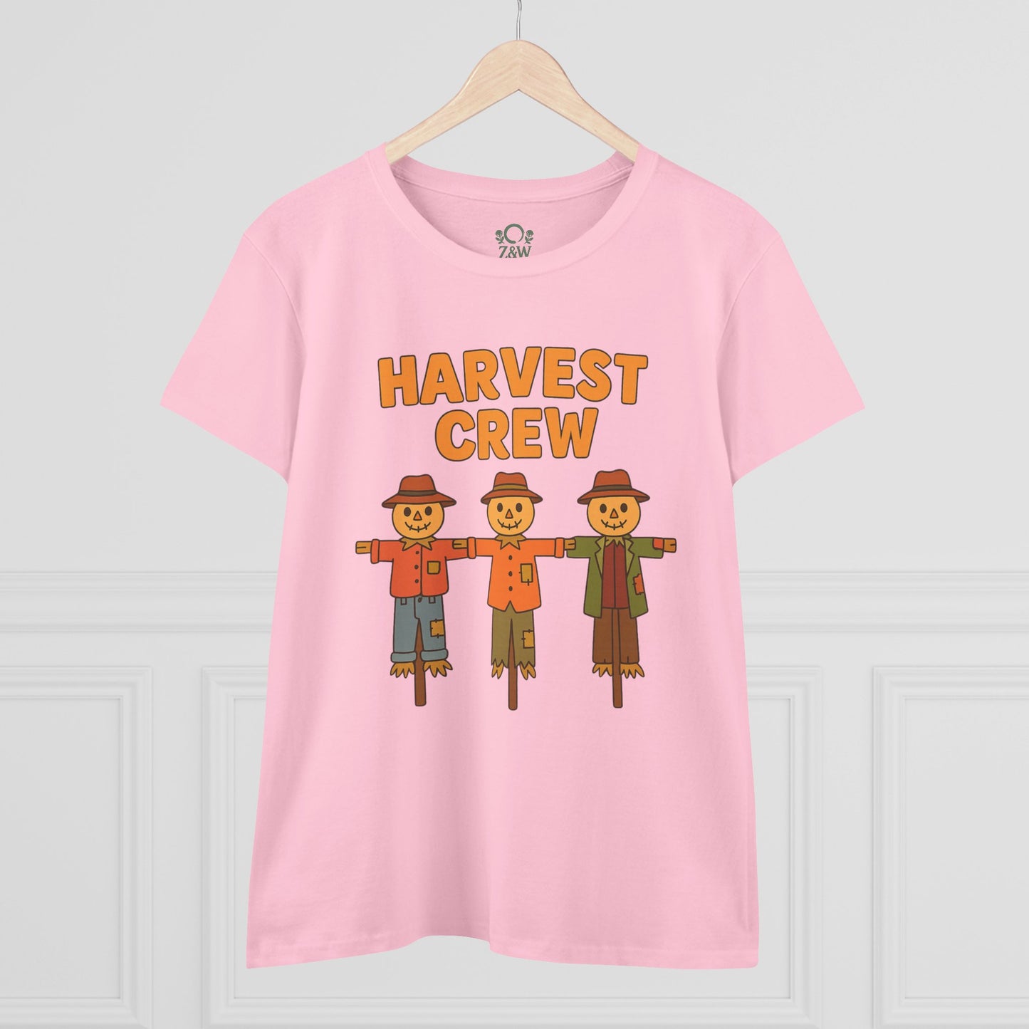 Front view of the Harvest Crew Halloween T-Shirt - Soft 100% Ring-Spun Cotton in pink, displaying three friendly scarecrows with the caption 'HARVEST CREW'.
