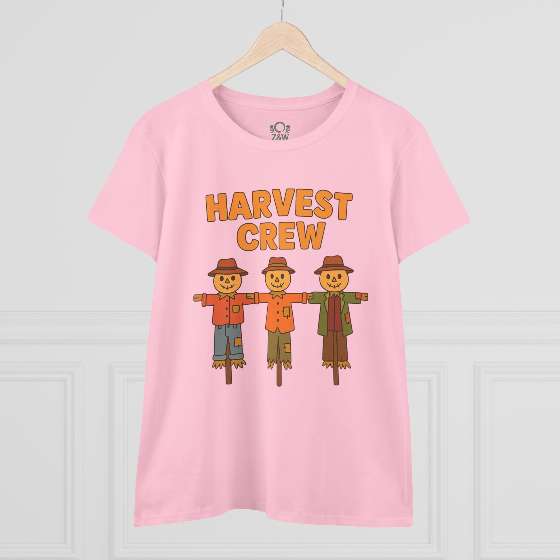 Front view of the Harvest Crew Halloween T-Shirt - Soft 100% Ring-Spun Cotton in pink, displaying three friendly scarecrows with the caption 'HARVEST CREW'.