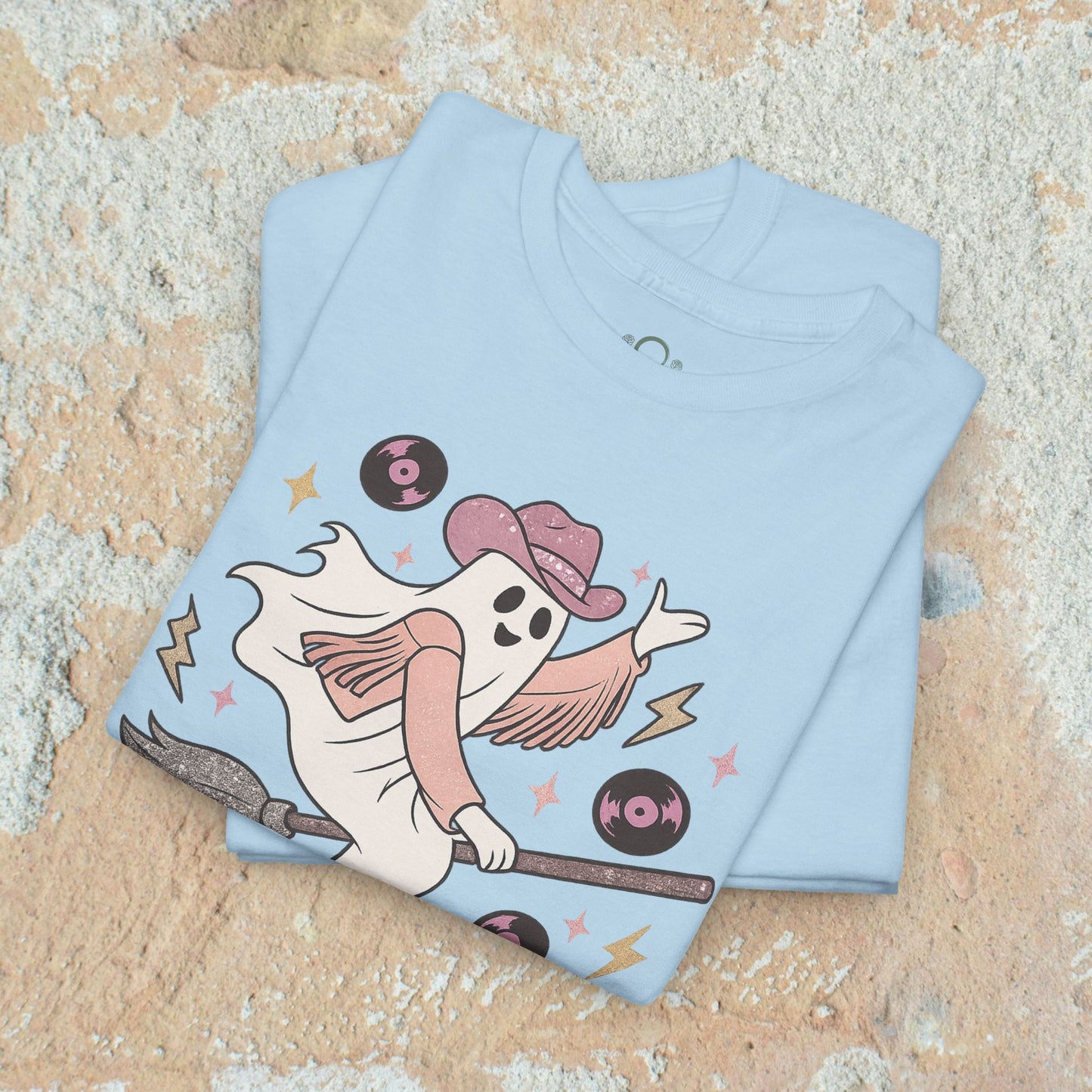 Spooky Cowgirl Graphic Tee - Soft Fabric, Eco-Friendly, Sizes S-5XL, showing a ghostly cowgirl on a broom in a light blue shirt, perfect for a fun outfit.