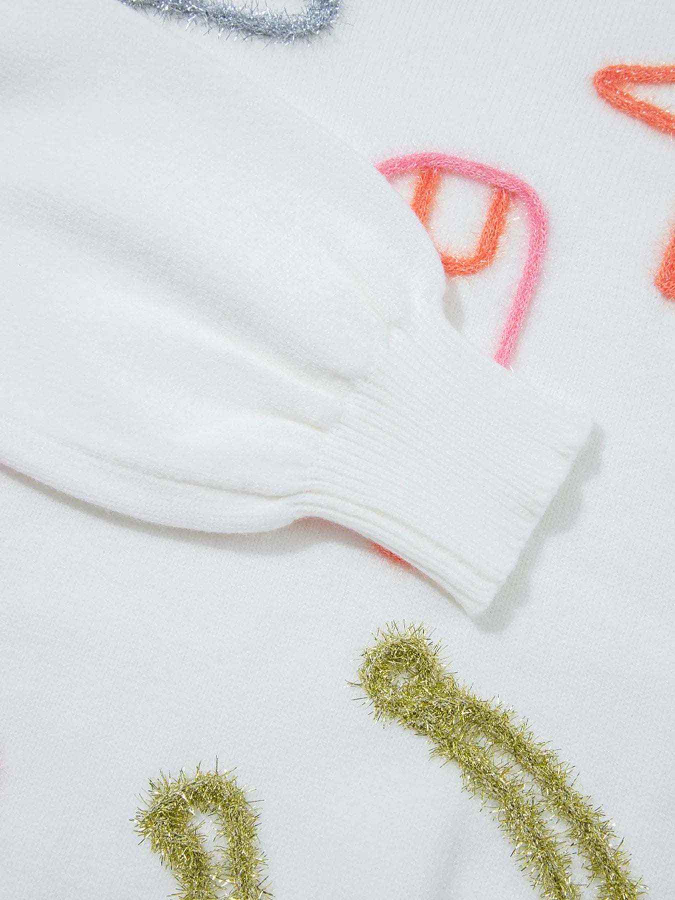 Detail of the sleeve cuff on the Western Style Knit Crew Neck Sweater with Horseshoe Star, featuring a slightly stretchy fabric with colorful embroidery.