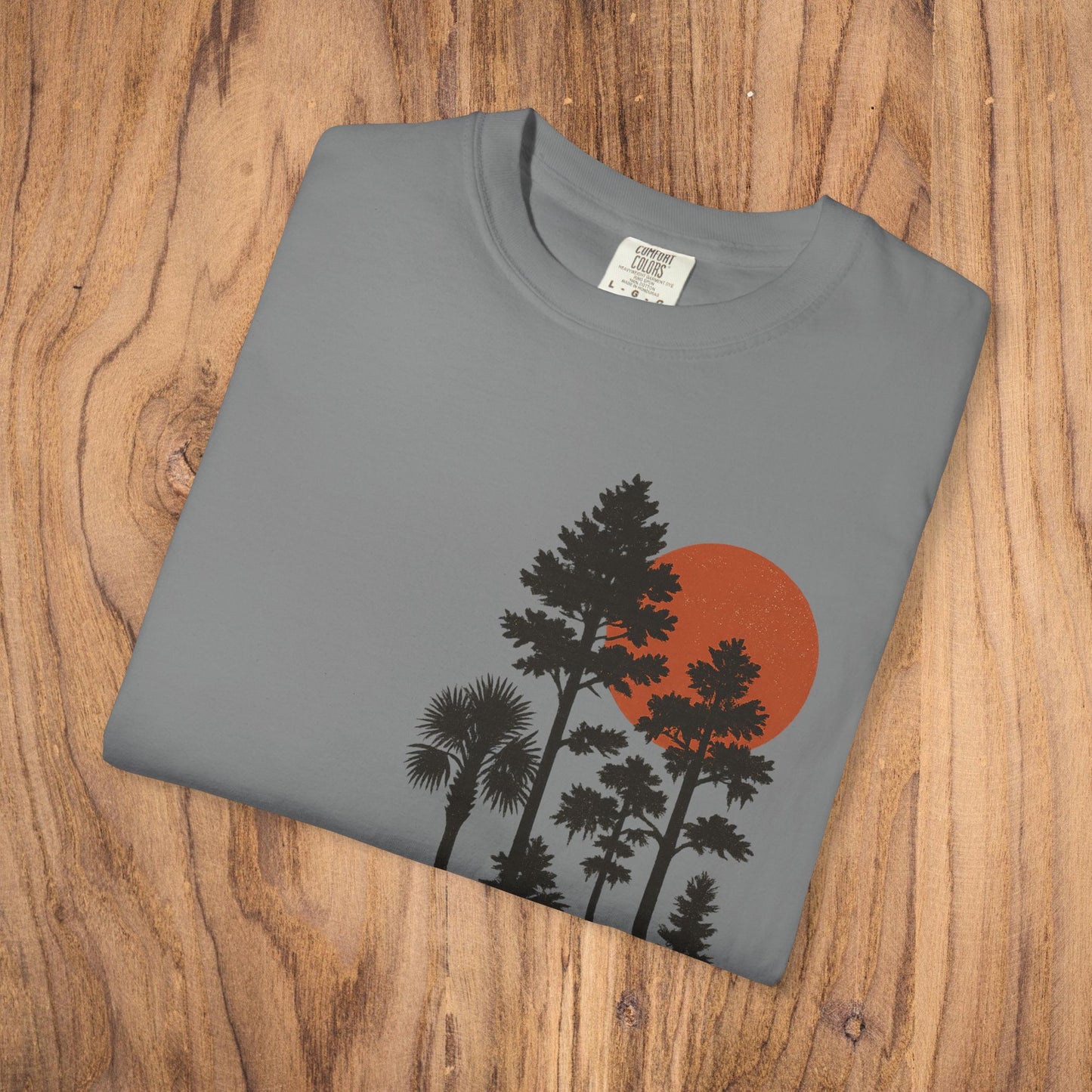 Folded view of the Sunset Trees Unisex T-Shirt featuring a beautiful sunset graphic with trees, made from soft 100% cotton for comfort.