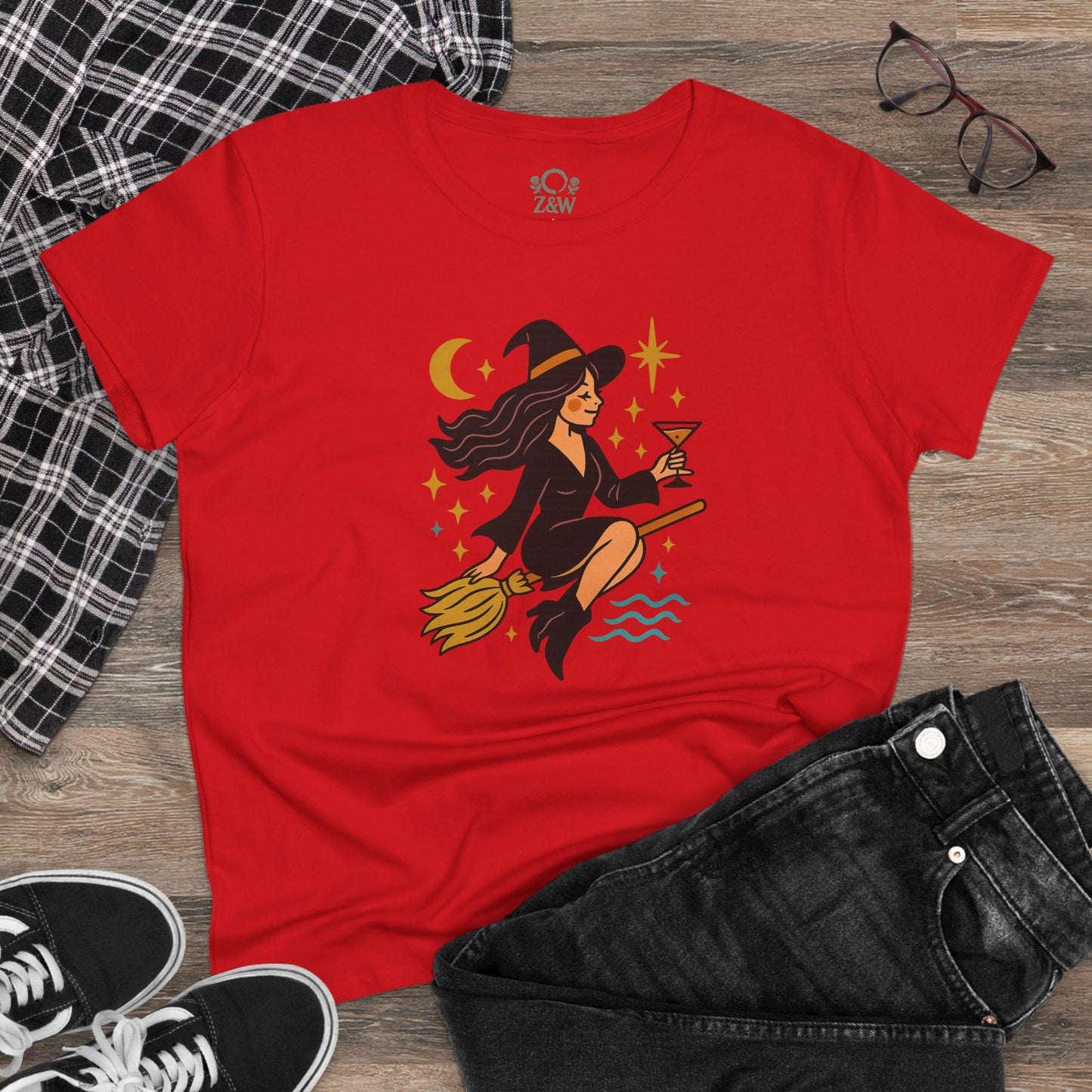 Casual styling of the Witchy Night Out Tee in red, paired with jeans and a plaid shirt, highlighting the whimsical witch graphic.