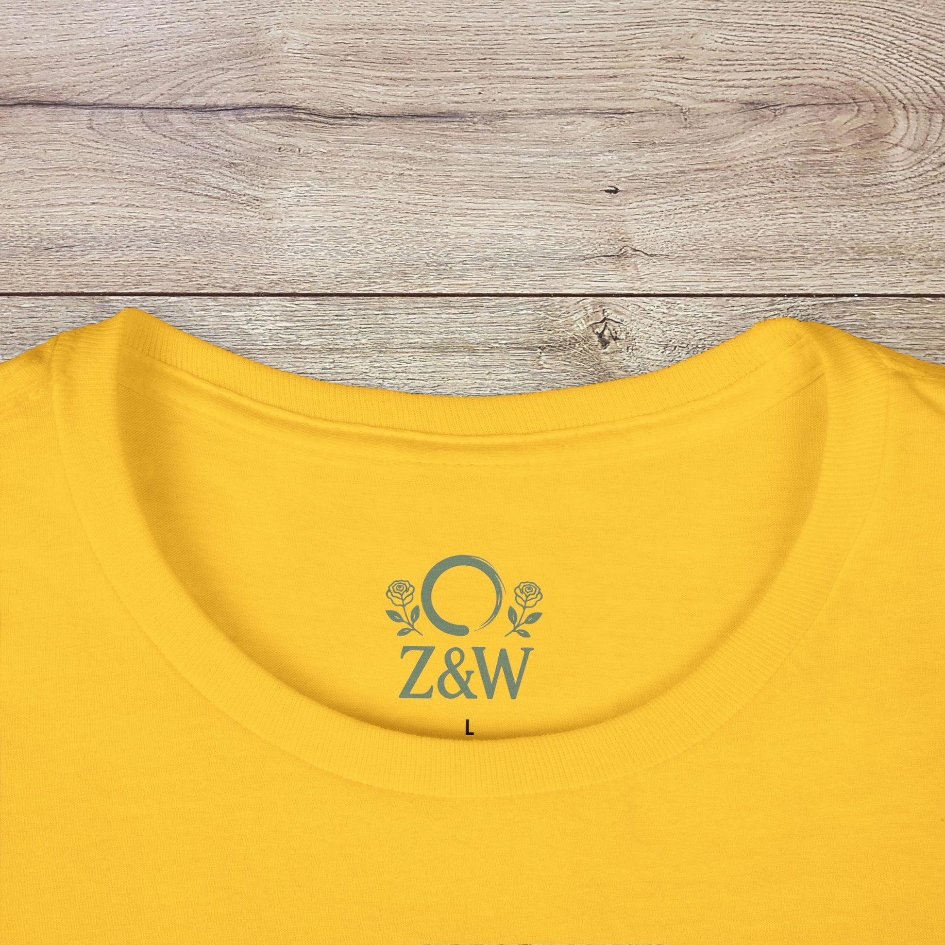 Close-up of the neckline on a yellow Halloween Family T-Shirt - Raising Little Monsters Cute Kids Tee for Parties & Costumes. Features a ribbed collar with brand logo for added style.