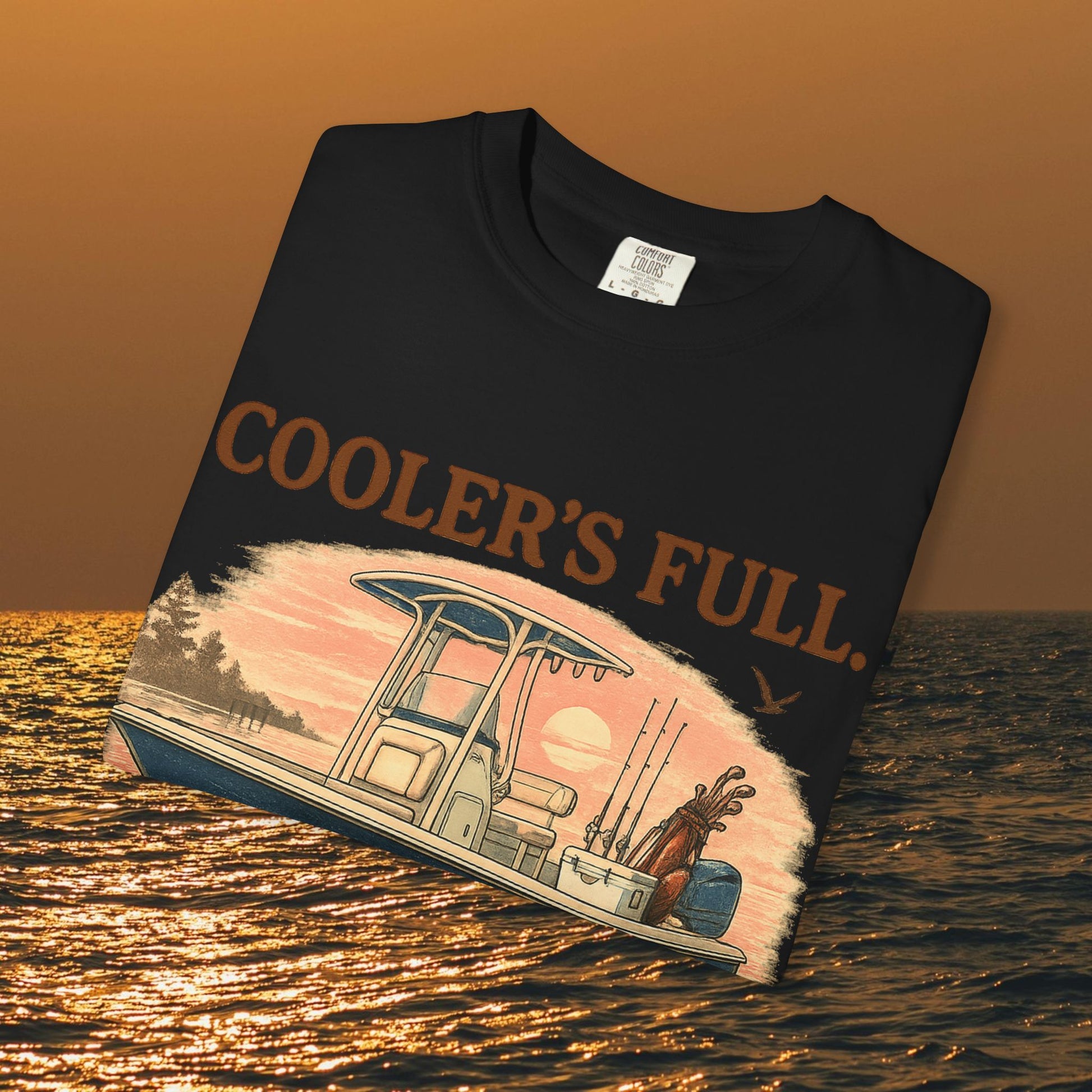 Men's & Women's Durable Cotton Full Tee with 'Cooler's Full' design laid flat on water backdrop, ideal for outdoor adventures.
