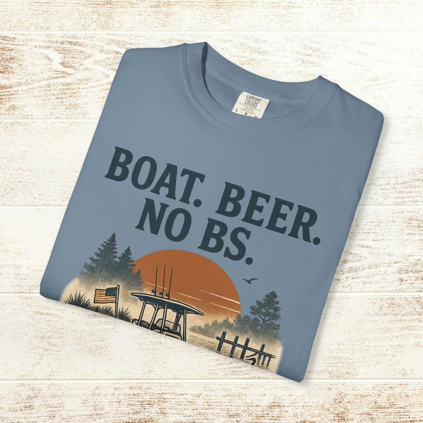 Flat lay image of Boat Beer No BS Tee in blue, featuring a relaxed design with a sunset and boat graphic, perfect for casual summer wear.