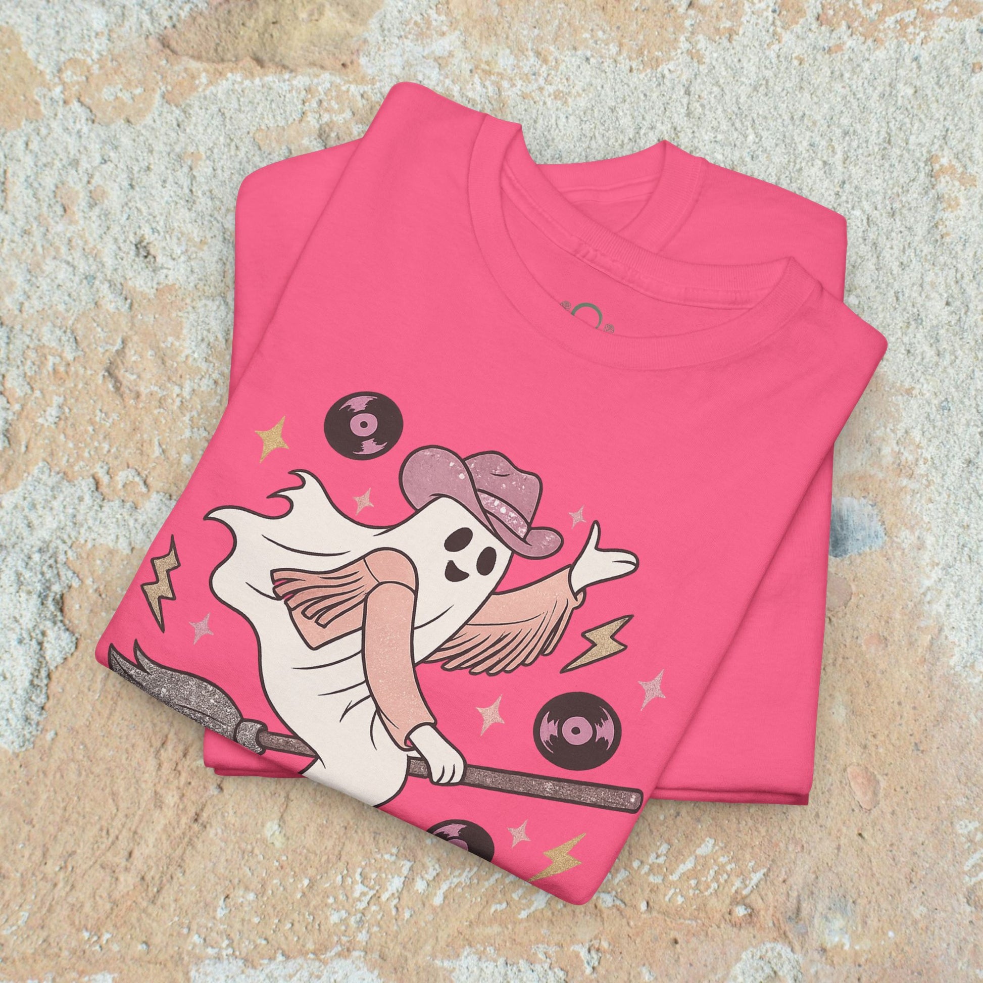 Spooky Cowgirl Graphic Tee - Soft Fabric, Eco-Friendly, Sizes S-5XL, featuring a cute ghost cowgirl with a broom and vinyl records on a pink background.