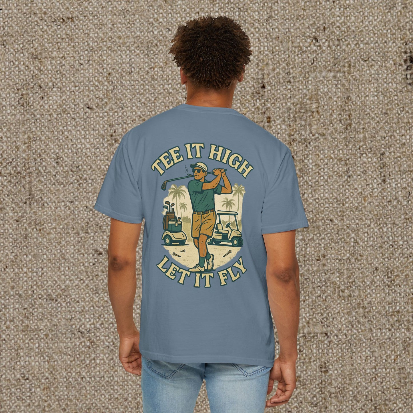Tee It High Let It Fly Graphic Tee for men in blue, showcasing a golfer's pose illustration on the back, combining comfort and style for golf enthusiasts.