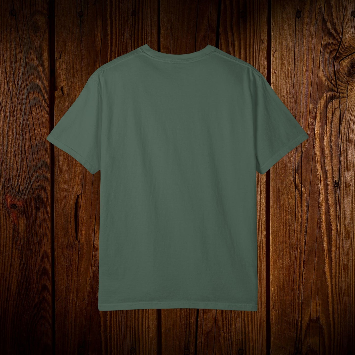 Back view of the Unisex Swamp-Bred Fairway-Fed Tee in a muted green color, highlighting the simple and classic style, made for comfort and durability.