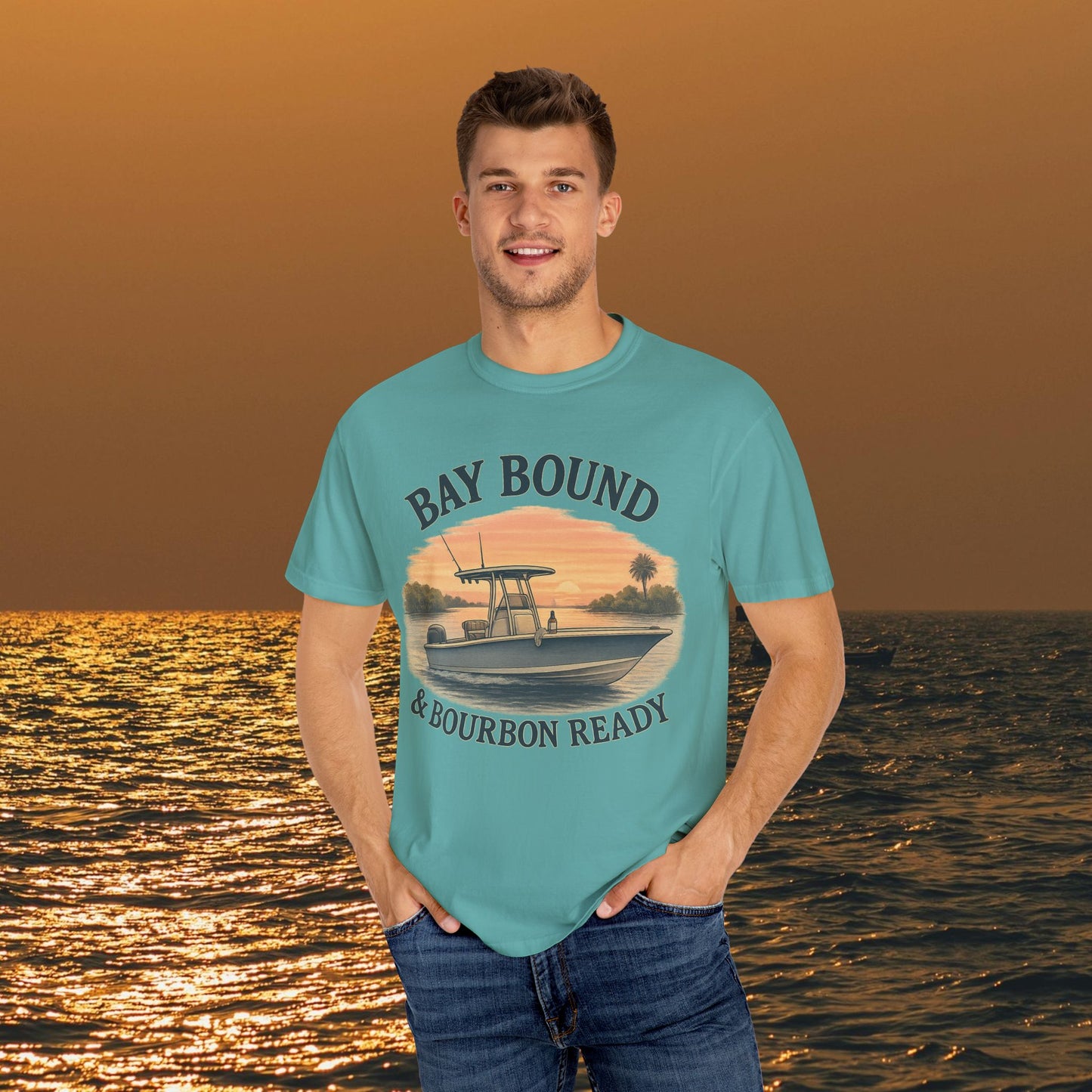 Man modeling a Bay Bound boating t-shirt in aqua, featuring a scenic boat design, ideal for summer fun and outdoor activities.