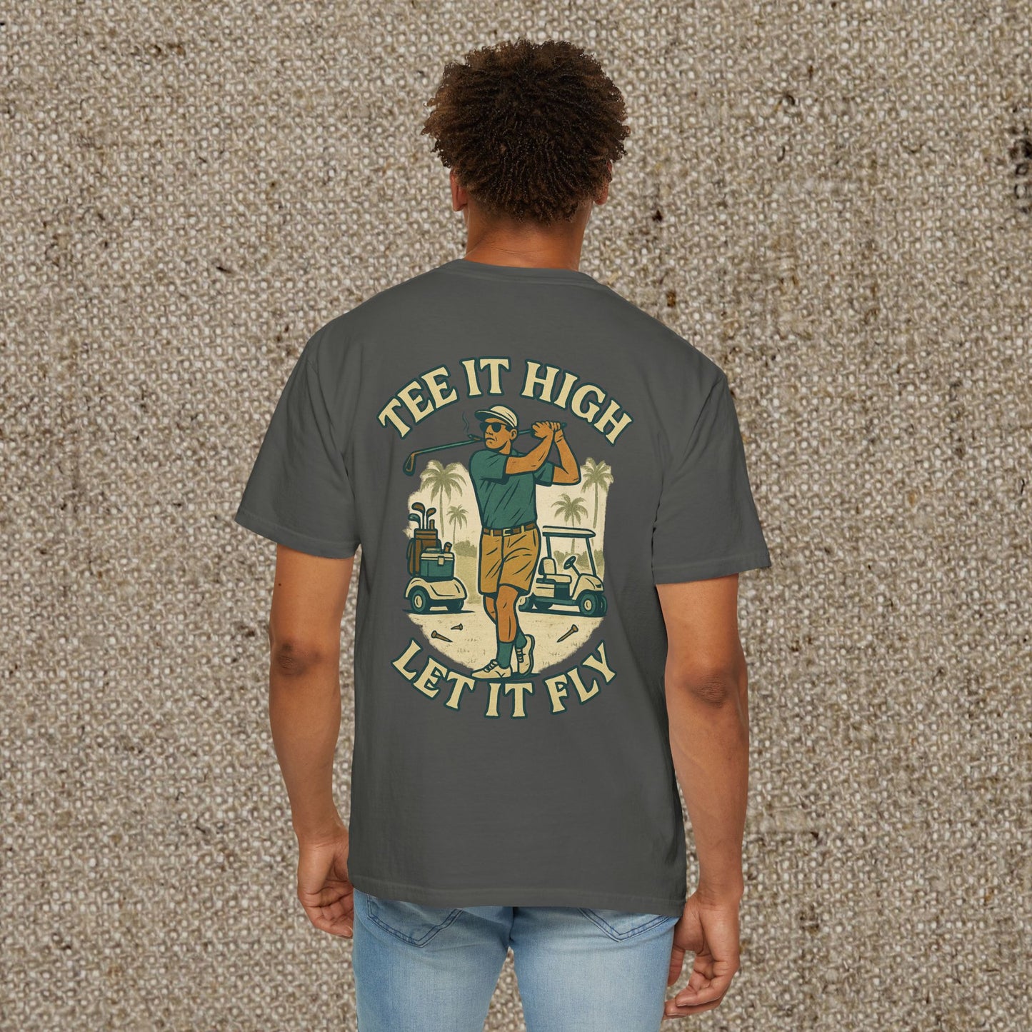 Back view of the Tee It High Let It Fly Graphic Tee in dark gray, showcasing a vibrant graphic of a golfer with palm trees and golf carts.