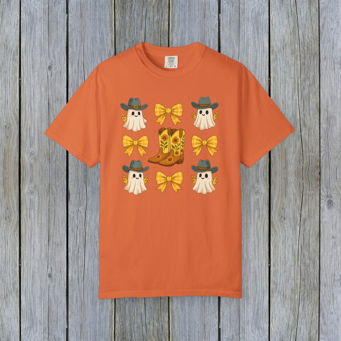 Cute Halloween T-Shirt showcasing cheerful ghosts in cowboy hats with stylish cowboy boots and yellow bows, ideal for all genders, crafted from eco-friendly fabric.