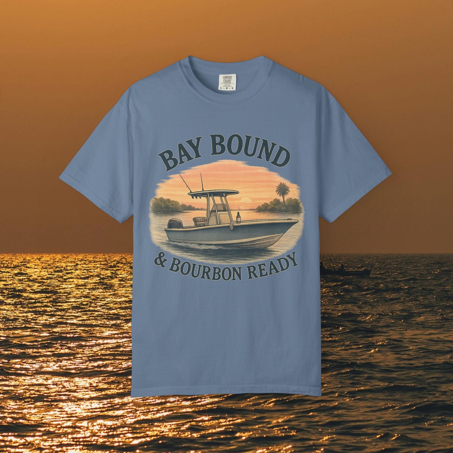 Bay Bound & Bourbon Ready T-Shirt in light blue, showcasing a boat design with a sunset backdrop, ideal for summer outdoor adventures.