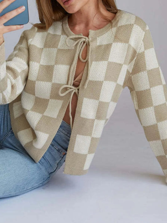 Side view of the Checkered Tie-Front Cropped Cardigan for Women, highlighting its tie-front design and cream and beige checkered pattern, made from slightly stretchy 100% polyester fabric.
