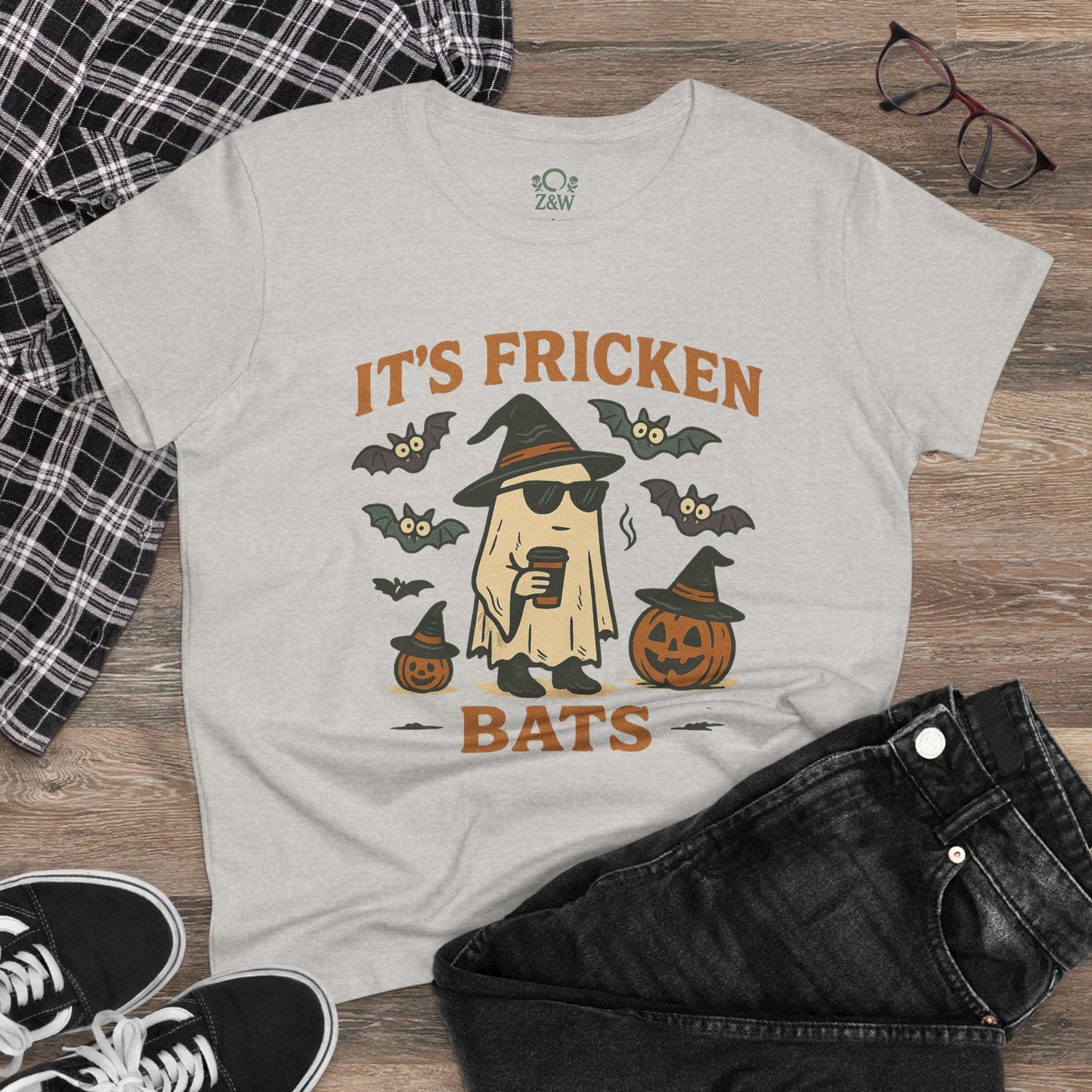 Trendy Halloween unisex t-shirt in heather grey displaying a playful ghost with sunglasses, surrounded by bats and pumpkins, ideal for trick-or-treating. Made from 100% cotton.