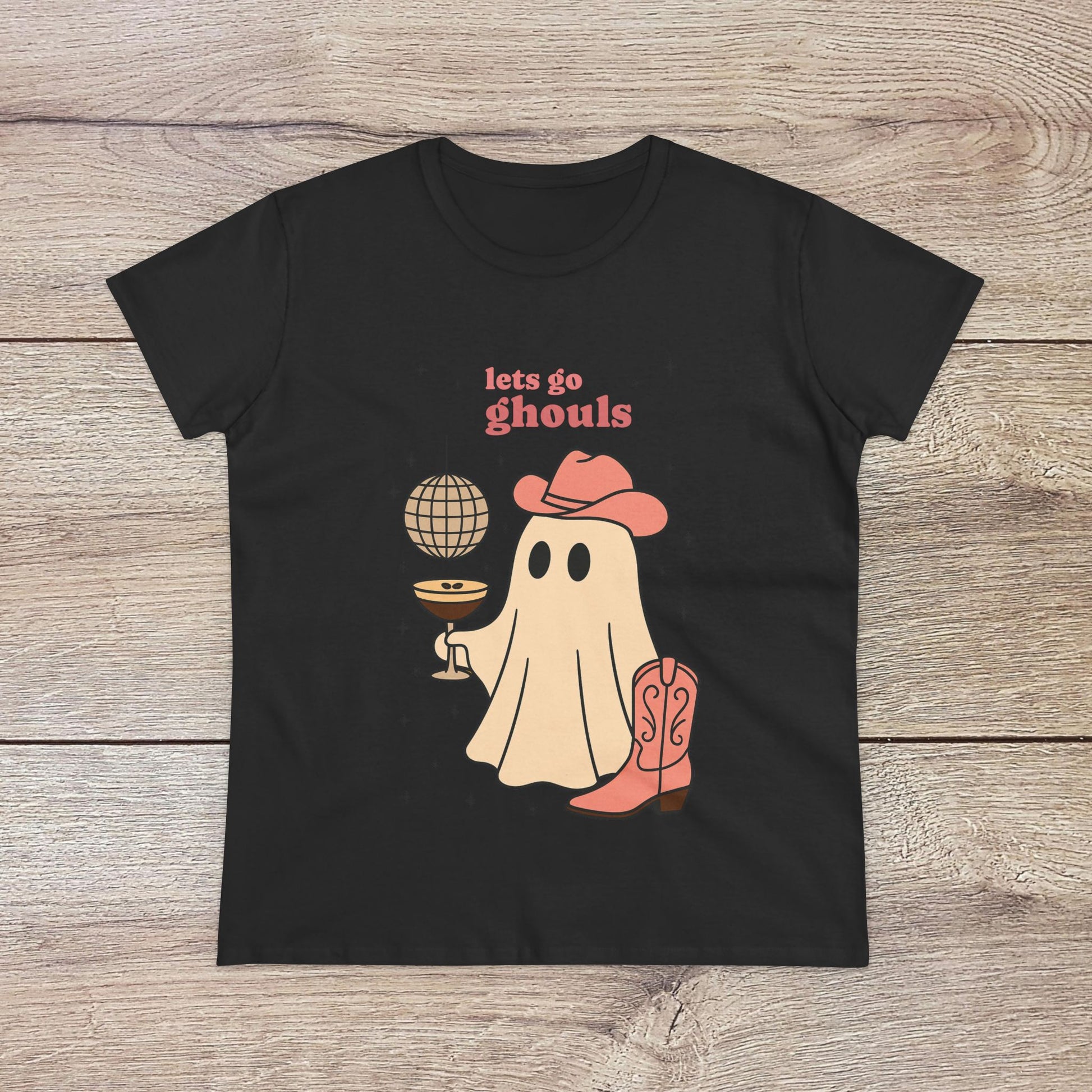 Let's Go Ghouls Tee in classic black featuring a charming ghost character with a drink and cowboy attire, an ideal choice for Halloween and everyday fun.