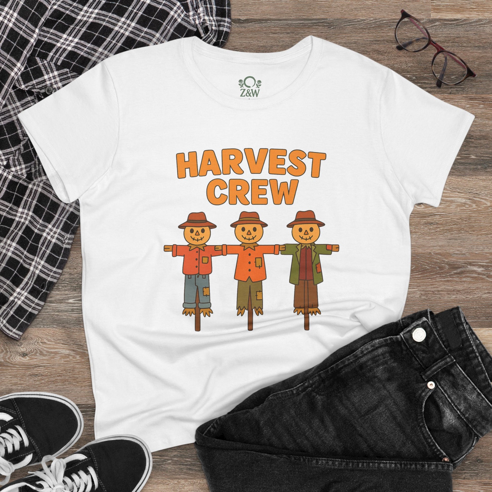 Lifestyle image of a white Harvest Crew Halloween T-Shirt displayed with jeans and accessories, showcasing its soft 100% ring-spun cotton fabric and classic fit.