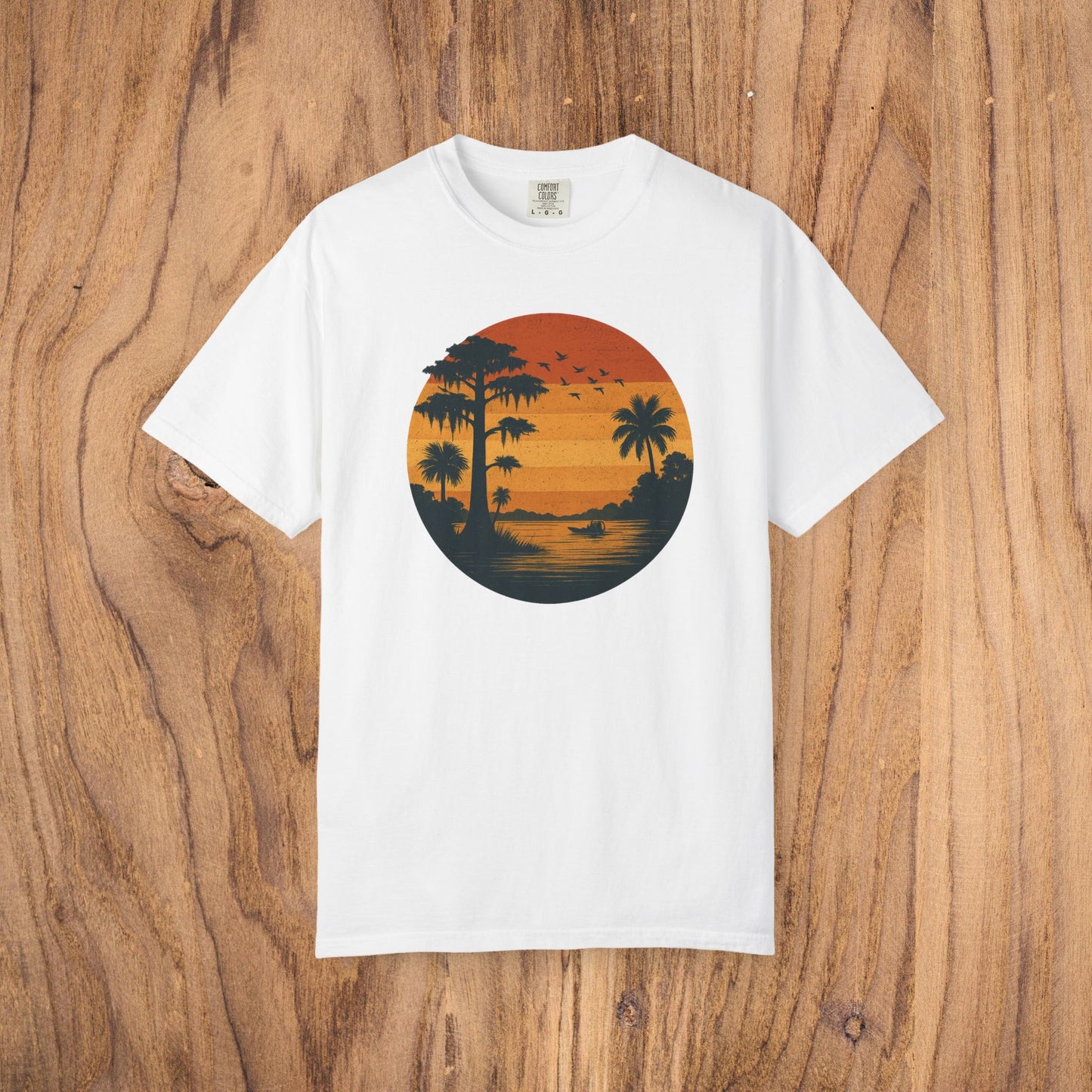 Unisex Garment-Dyed Sunset Tee in classic white featuring an eye-catching sunset graphic with palm trees, ideal for summer fashion.