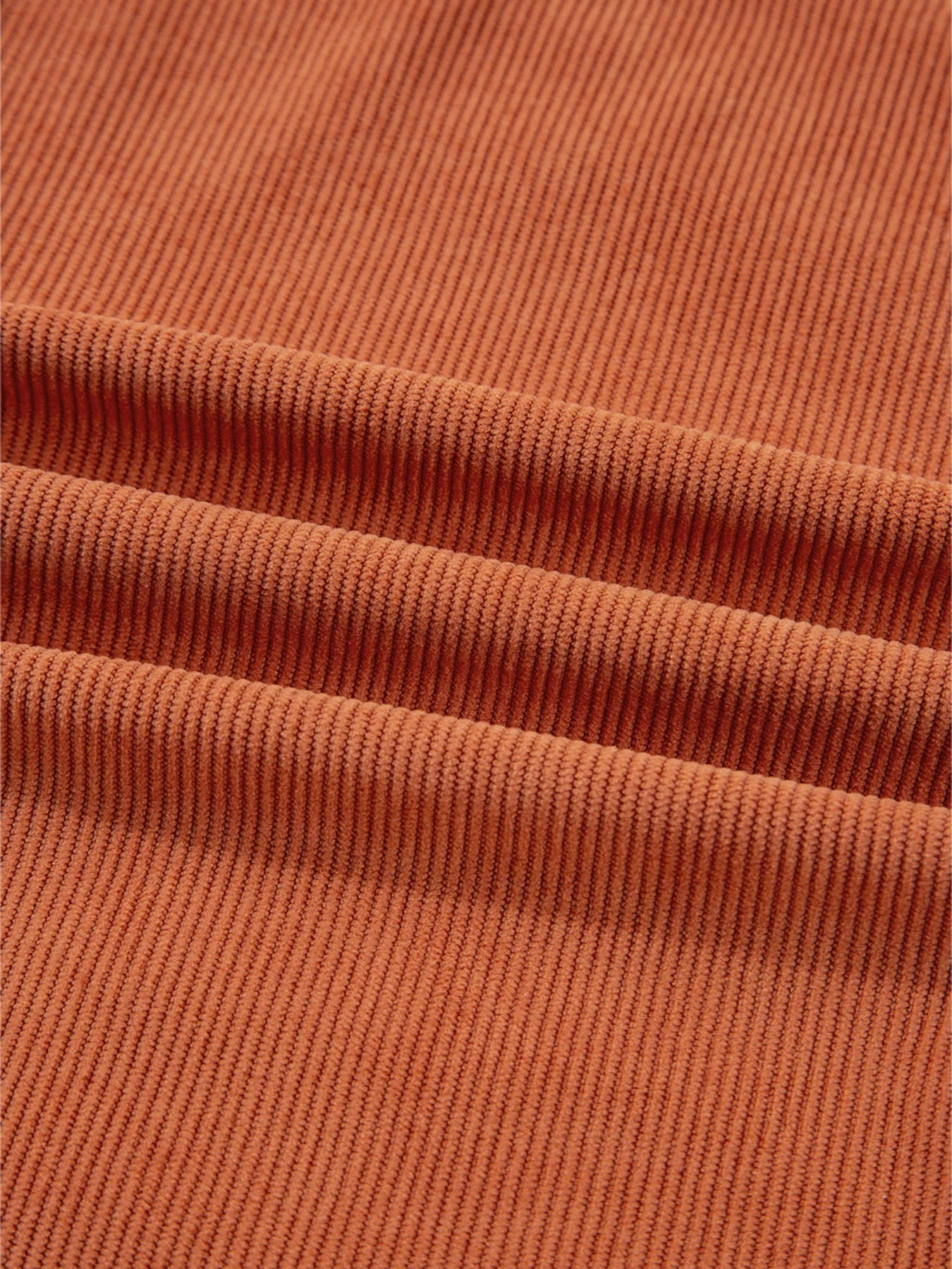 Close-up view of the ribbed texture of the fabric on the Corduroy Western Mini Dress With Embroidered Patch Pocket, showcasing the quality and softness of the 100% polyester material.