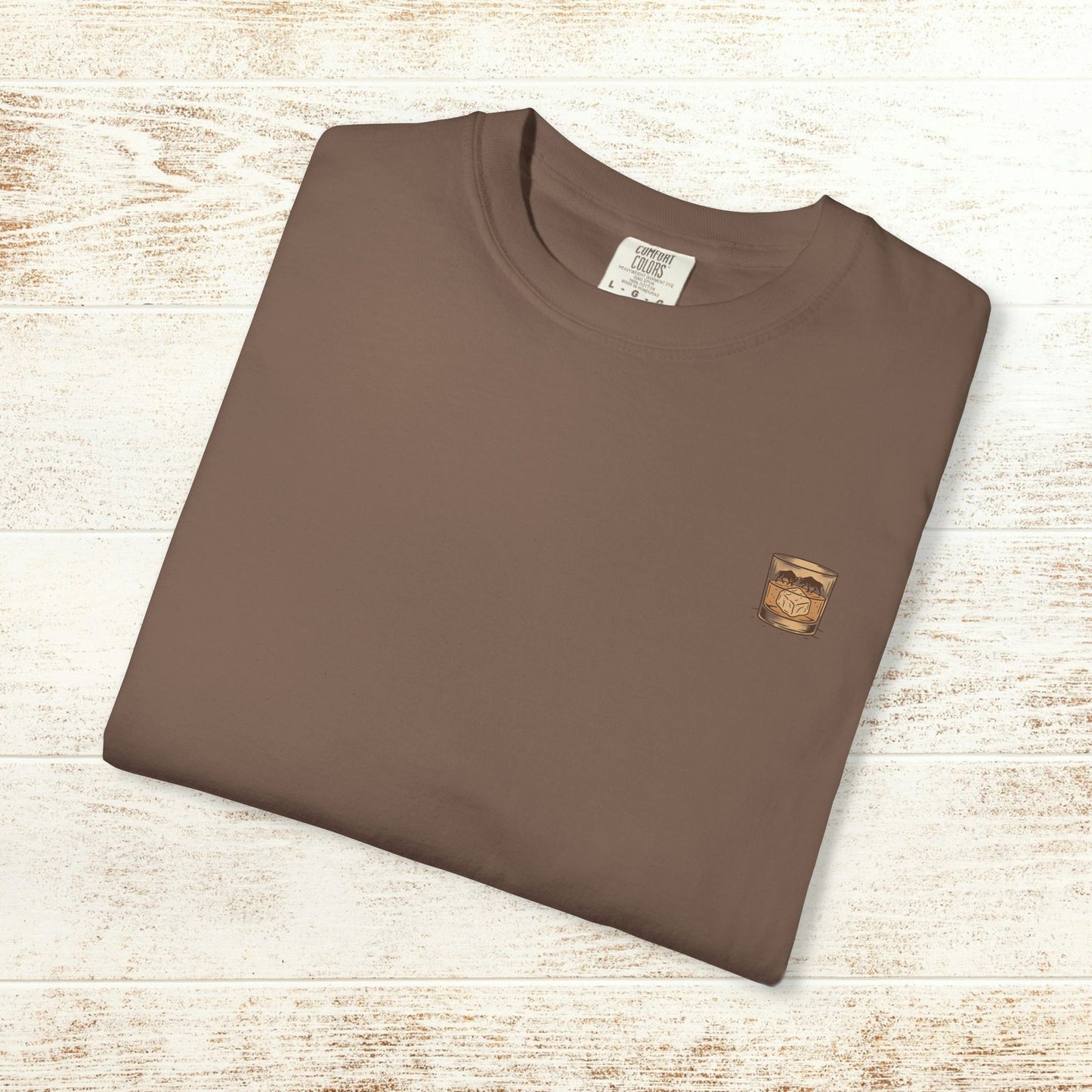 Folded Rodeo On The Rocks Tee in brown color, highlighting the unique garment-dyed style with a soft feel and made from 100% US cotton, available in sizes S-4XL.
