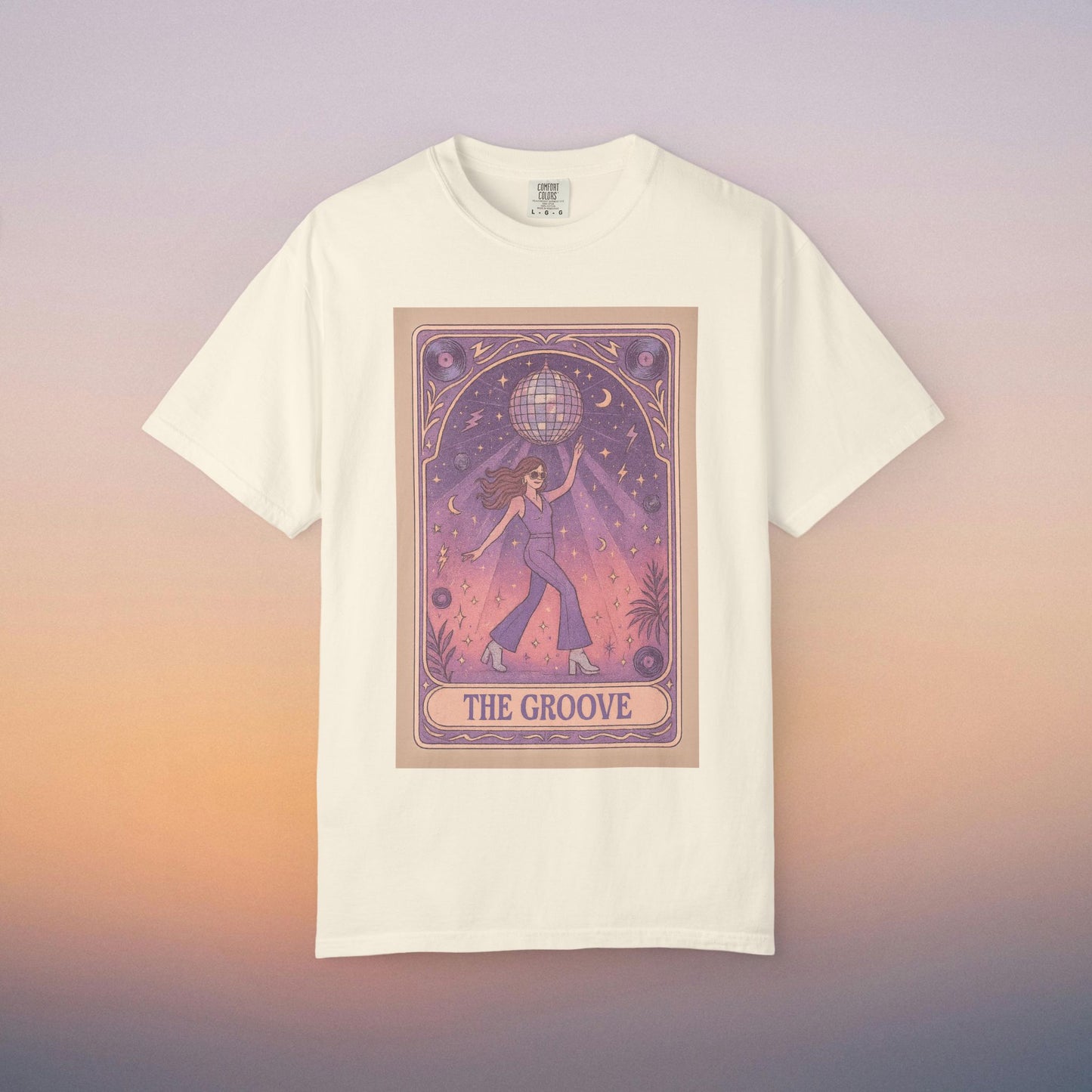 Groove Tarot Graphic Tee in cream color, featuring an artistic design of a figure holding a globe with a starry background. Made from 100% ring-spun cotton for ultimate comfort, available in unisex fit, sizes S-4XL.