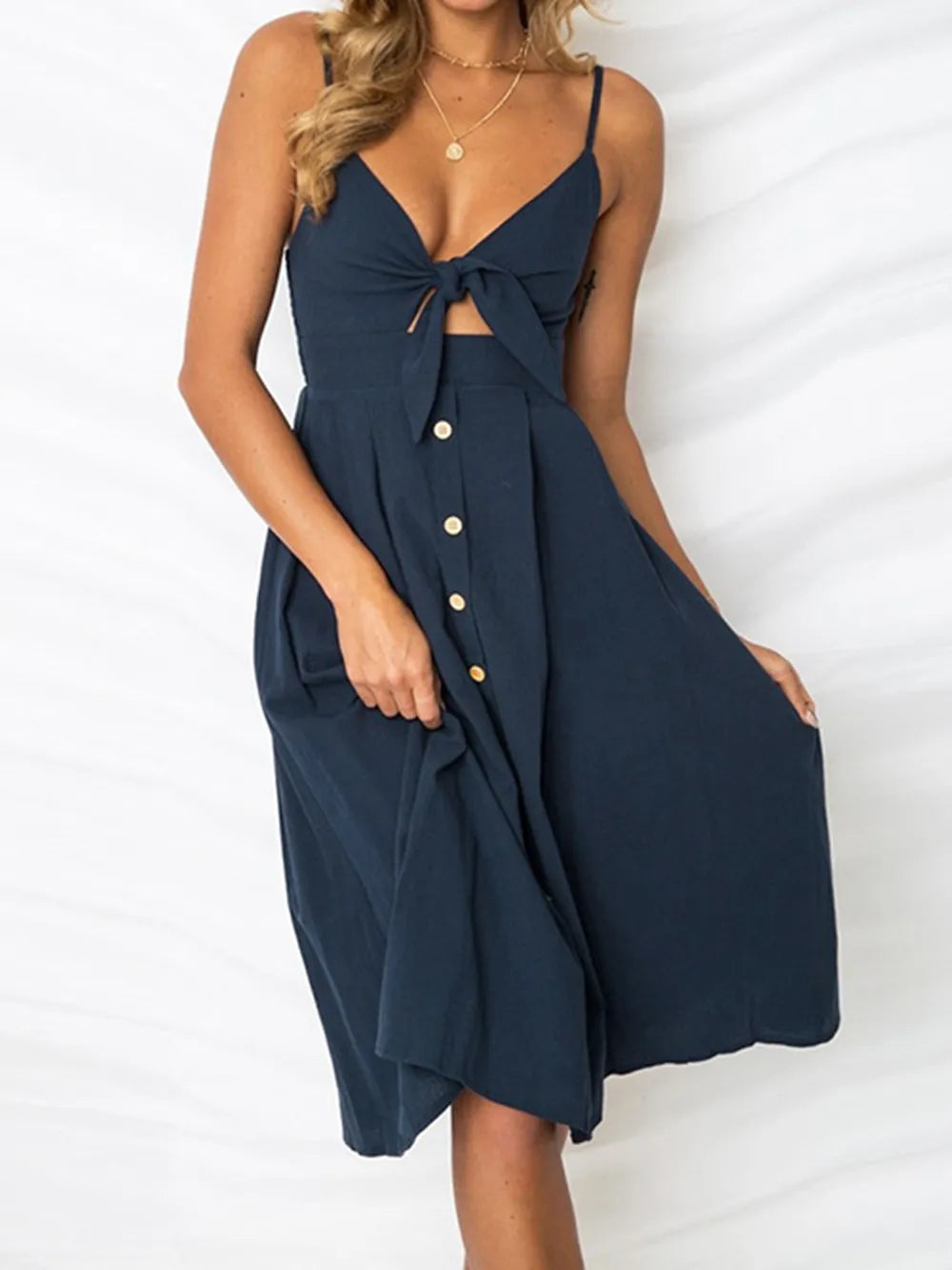 Cutout Smocked Sweetheart Neck Cami Dress with Decorative Button and Opaque Design in deep navy, beautifully styled and flowing gracefully.