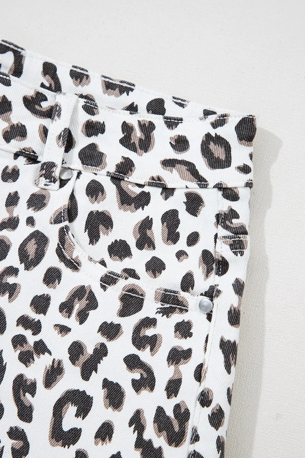 Leopard Frayed Hem Denim Shorts showcasing a close-up view of the fabric pattern, highlighting the trendy leopard print design, perfect for summer fashion.