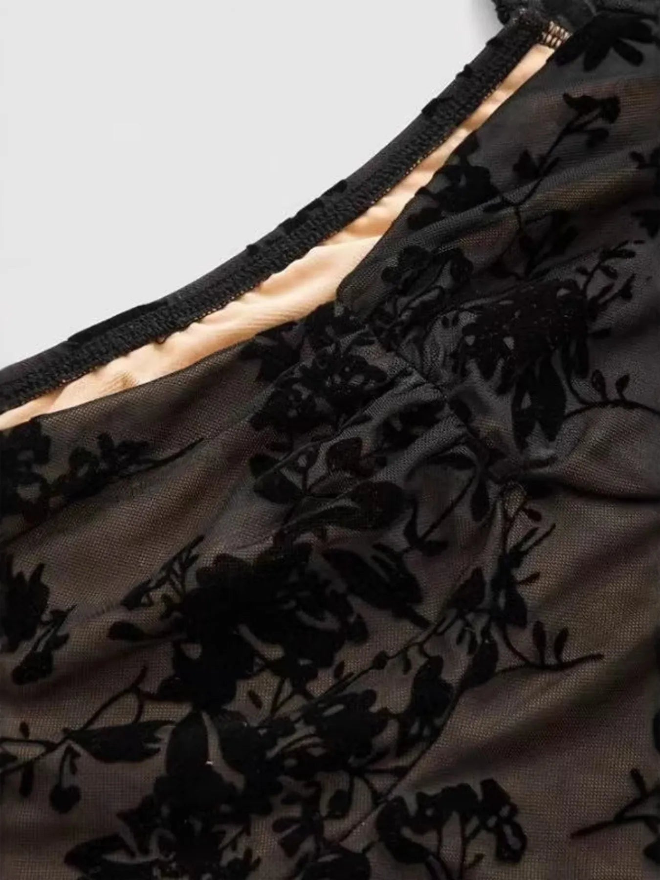 Detailed view of the floral lace design on the Women's Lace Flare Sleeve Mini Dress with Tied Detail, highlighting the elegant patterns and high-quality fabric.